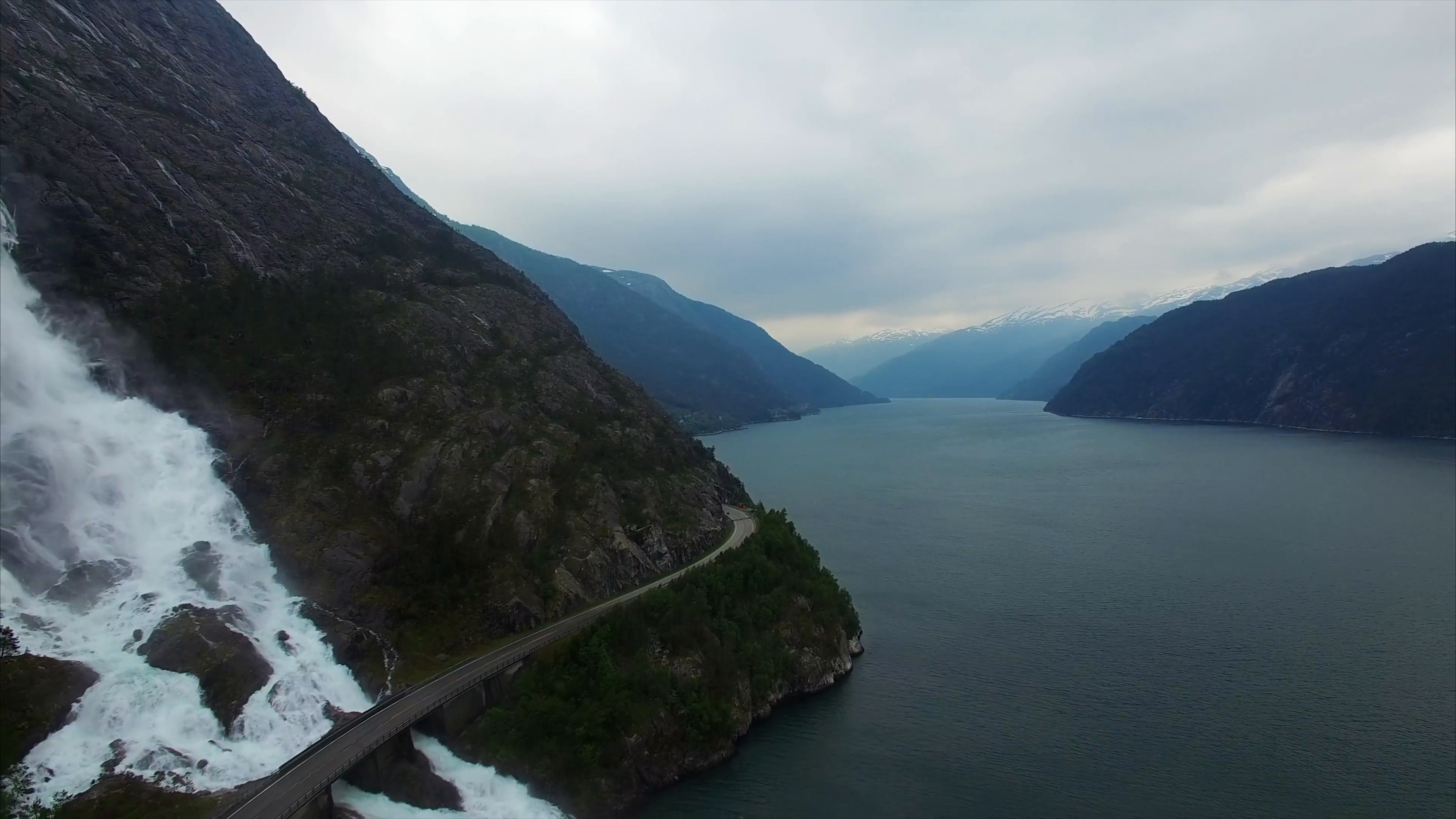 Aerial footage of waterfall Langfossen in Norway and road bridge ...