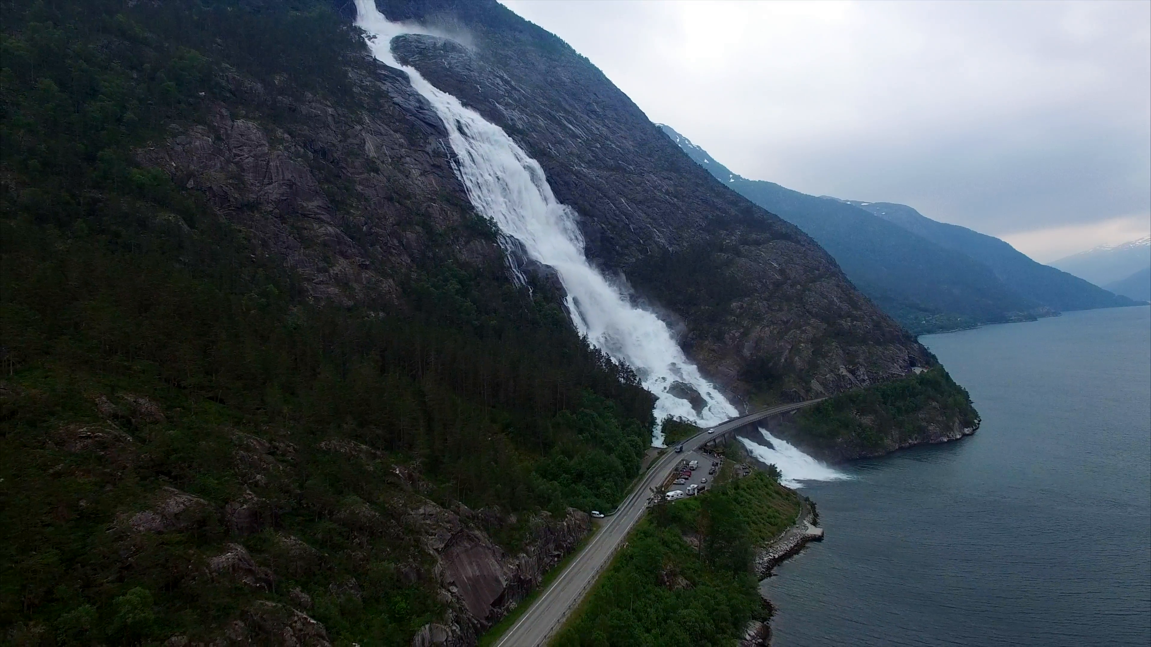 Aerial footage traffic on the bridge above the Langfossen waterfall ...