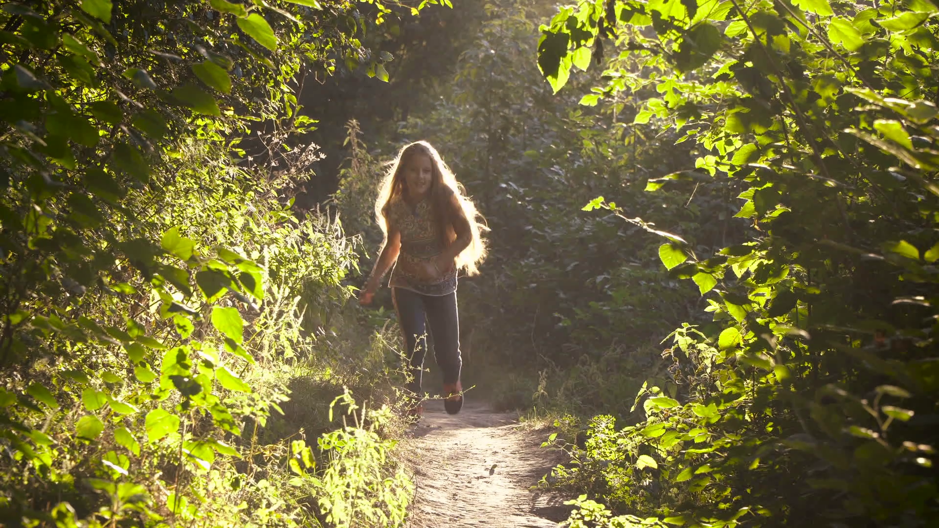 Girl with long hair running along a path in the woods. 4K Stock ...