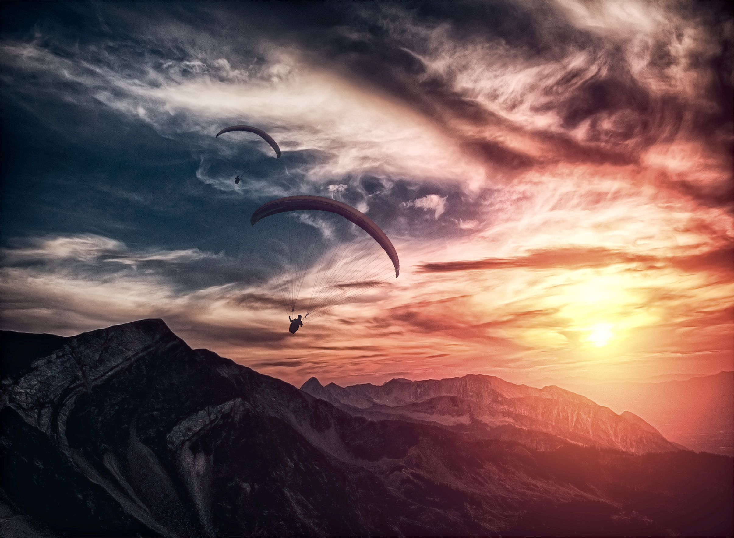 Into the atmosphere - paragliding over mountain ridge photo