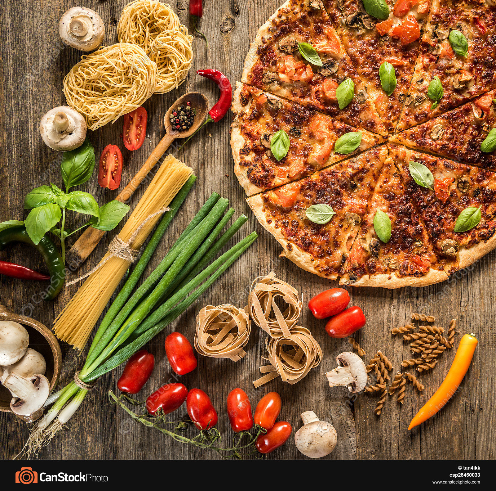 Italian food background with pizza, raw pasta and vegetables ...