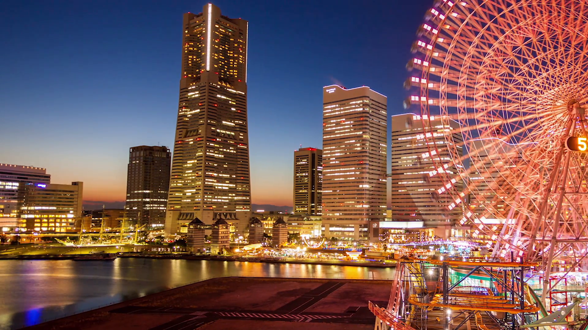 Dolly left timelapse Nighttime view of Yokohama Buildings and Ferris ...