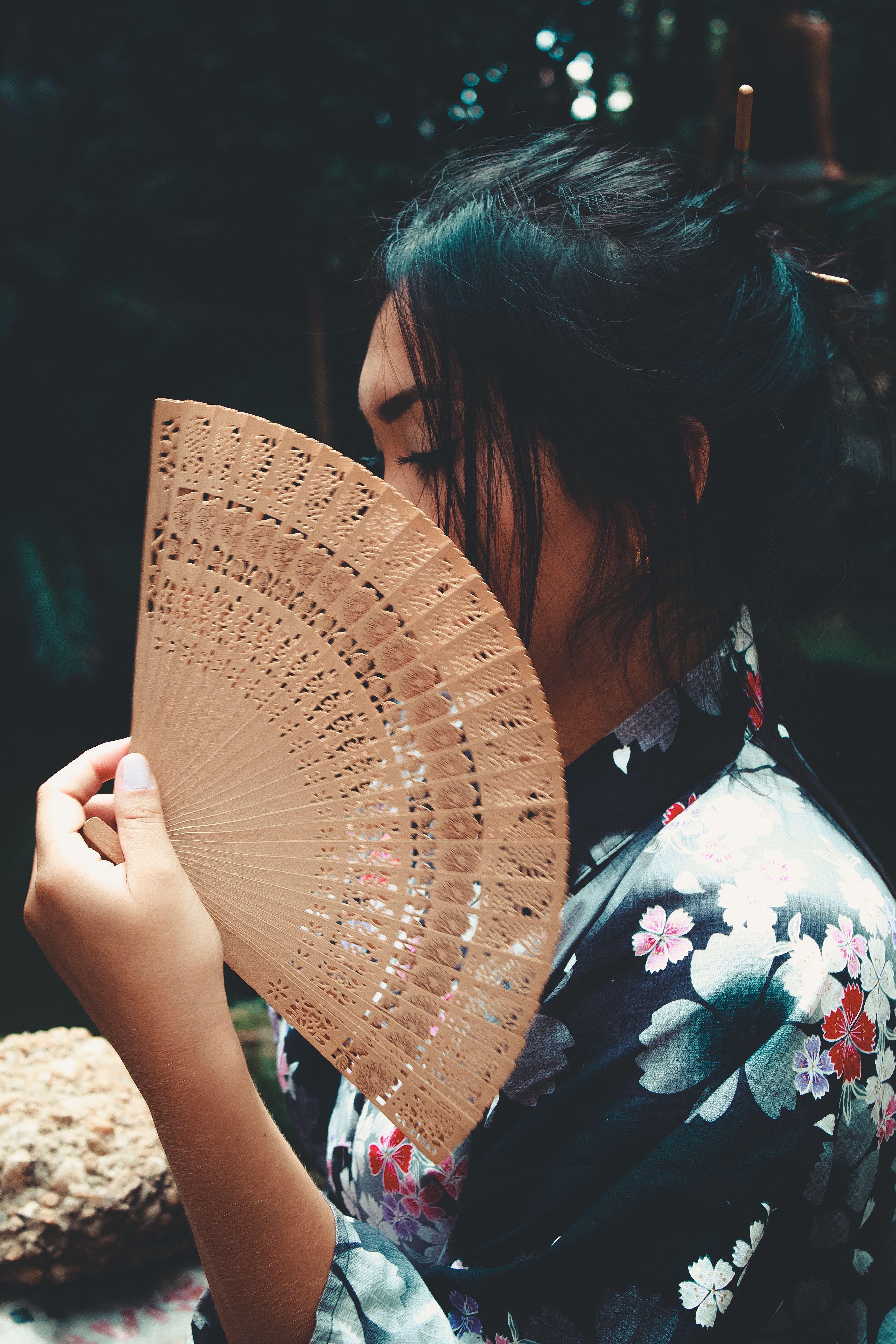 Japanese woman holding brown hand fan photo