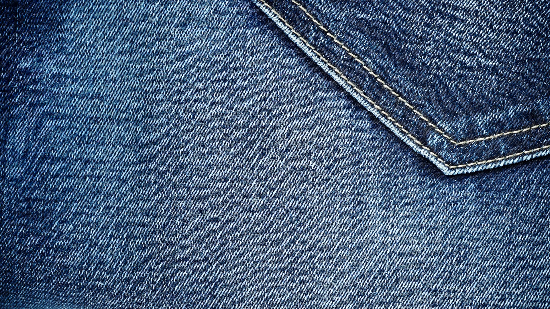 Closeup detail of blue denim jeans back pocket, texture background ...