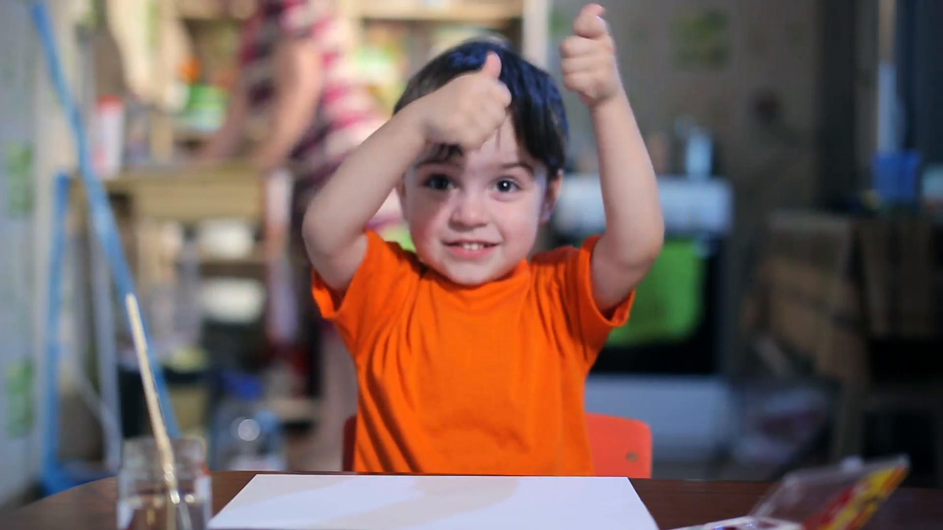 Joyful child at the table with a brush Stock Video Footage - VideoBlocks