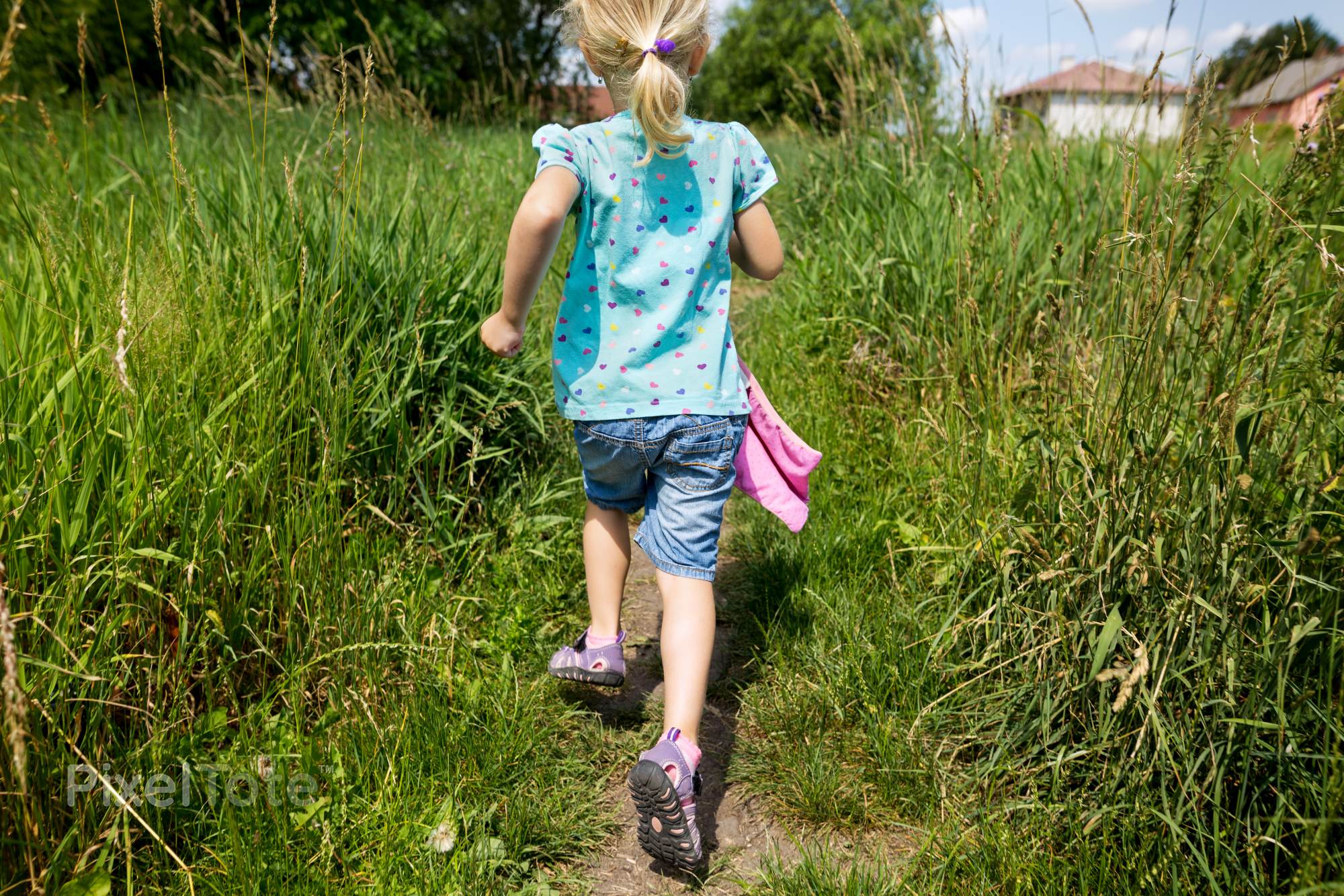 Little Joyful Girl Running on a Trail Through Tall Grass Stock Photo ...