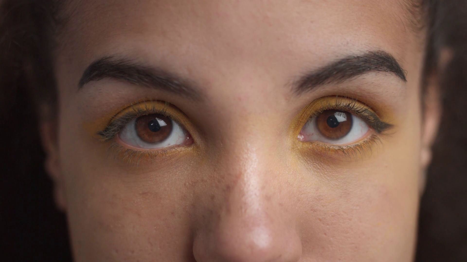 women's eyes with yellow eyeshadow closeup looking at camera Stock ...
