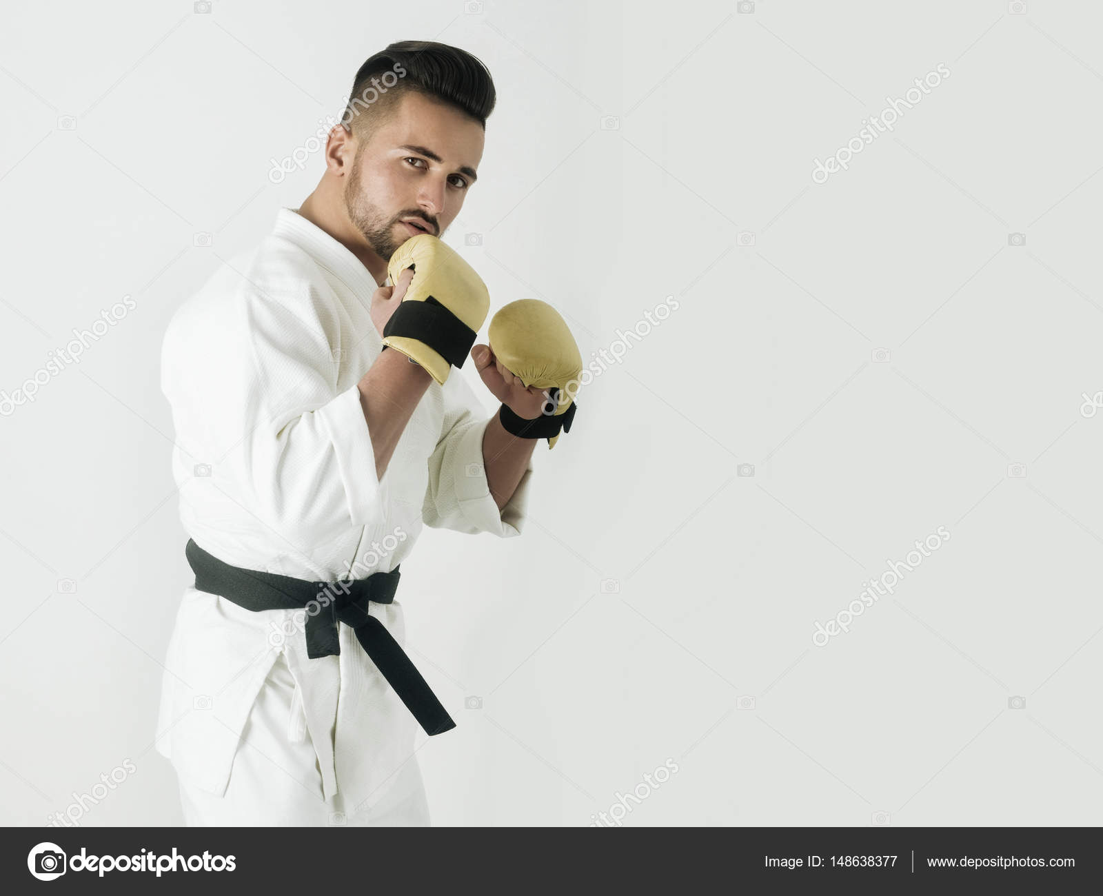 Master with black belt. Male fighter in kimono posing isolated on ...