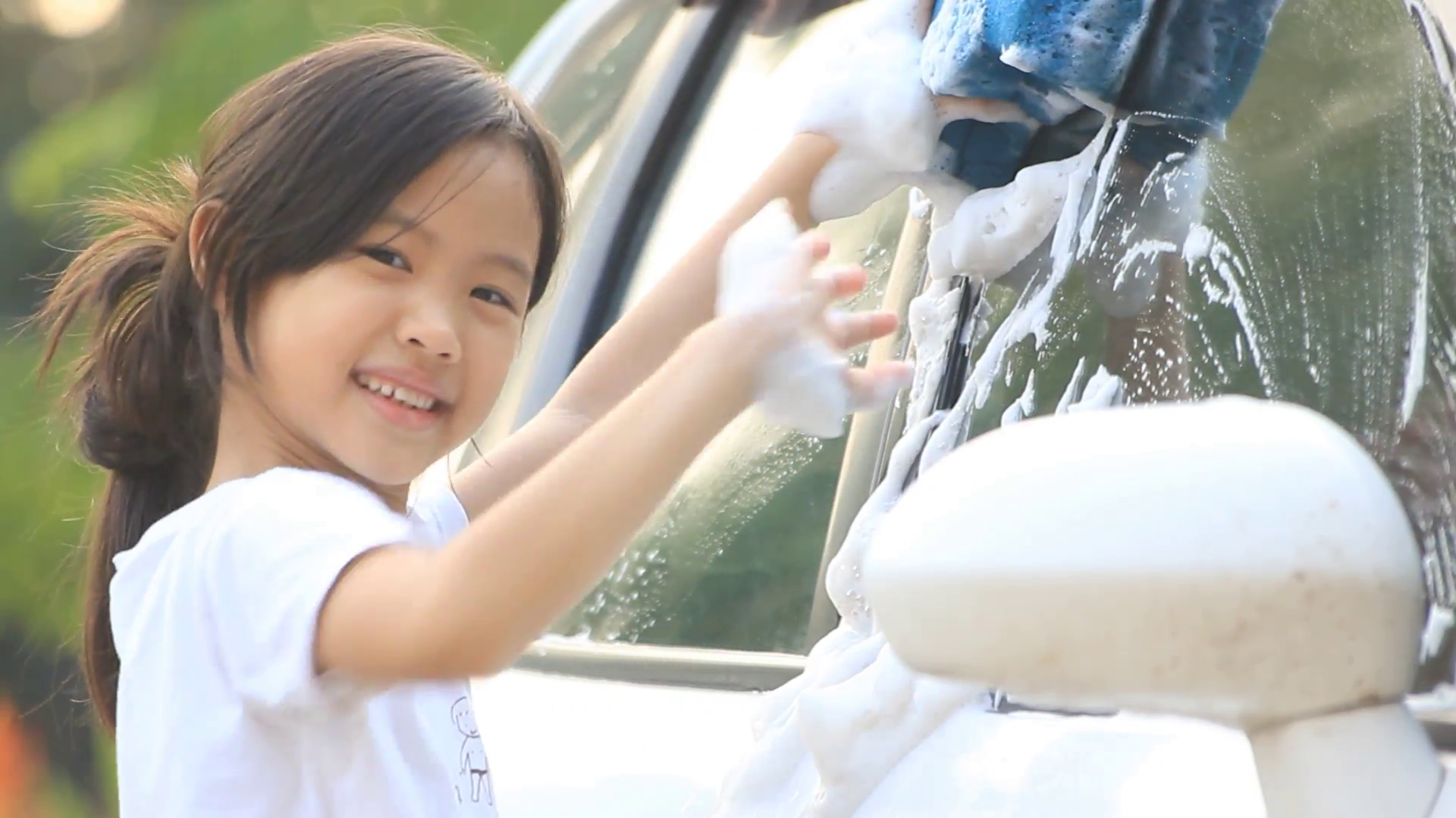 Little Asian kid washing car at home Stock Video Footage - Videoblocks