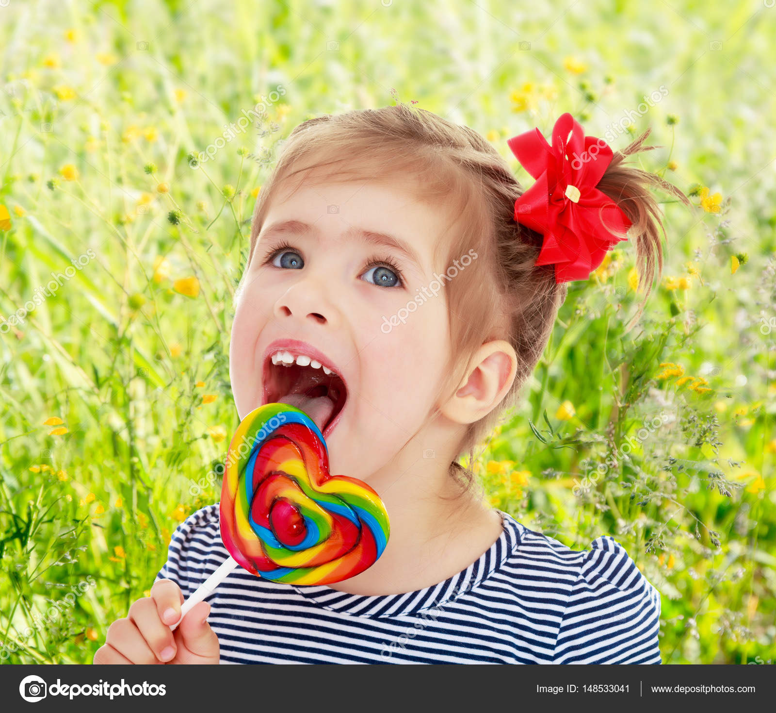 Girl licks candy on a stick — Stock Photo © lotosfoto1 #148533041