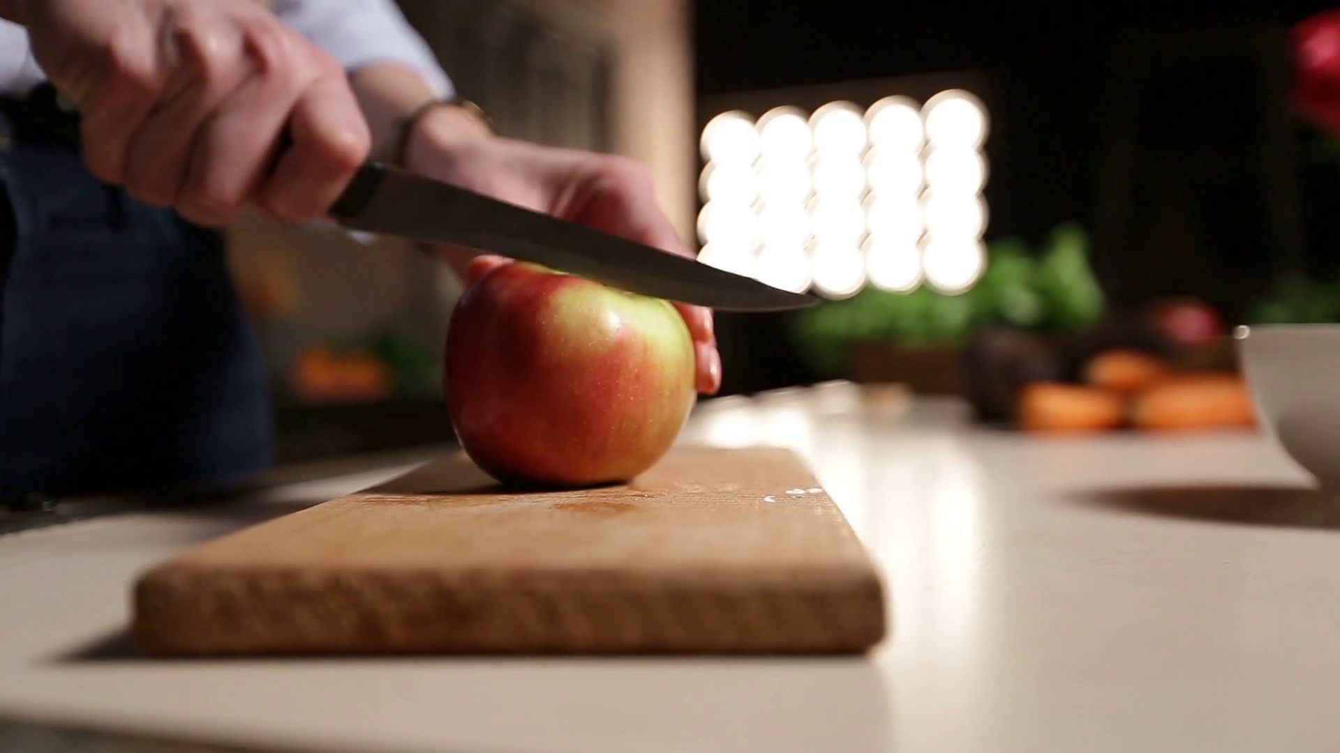 Woman with knife cutting apple on chopping board Stock Video Footage ...