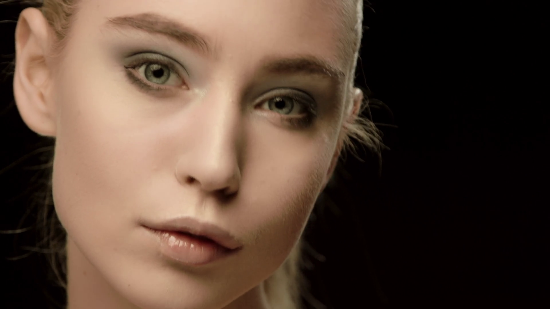 Ukrainian fashion model face closeup isolated on black background ...