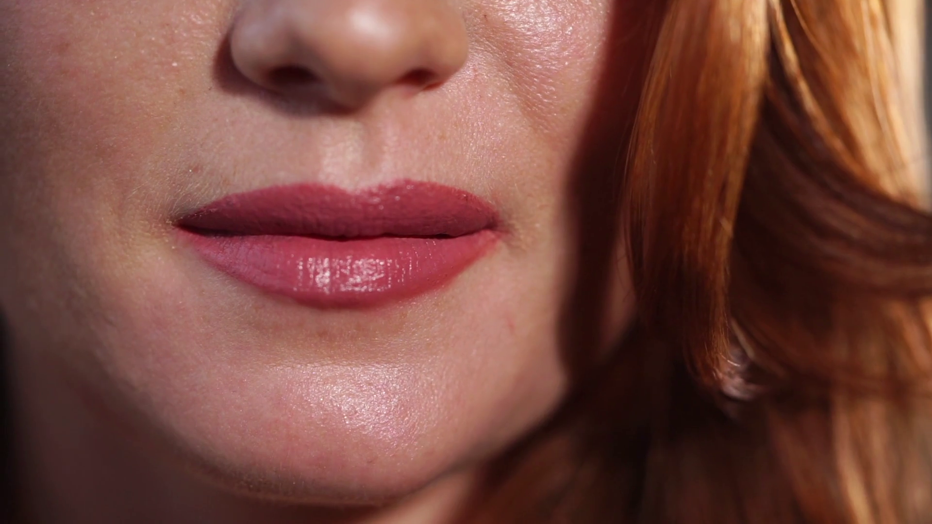 close up shot of the woman's tender lips, the lady erotically bites ...