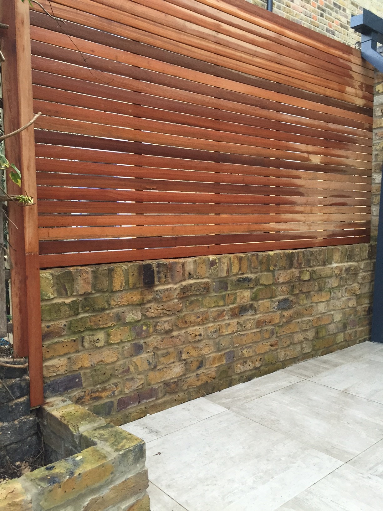 hardwood screen trellis on yellow stock brick wall london | Home ...