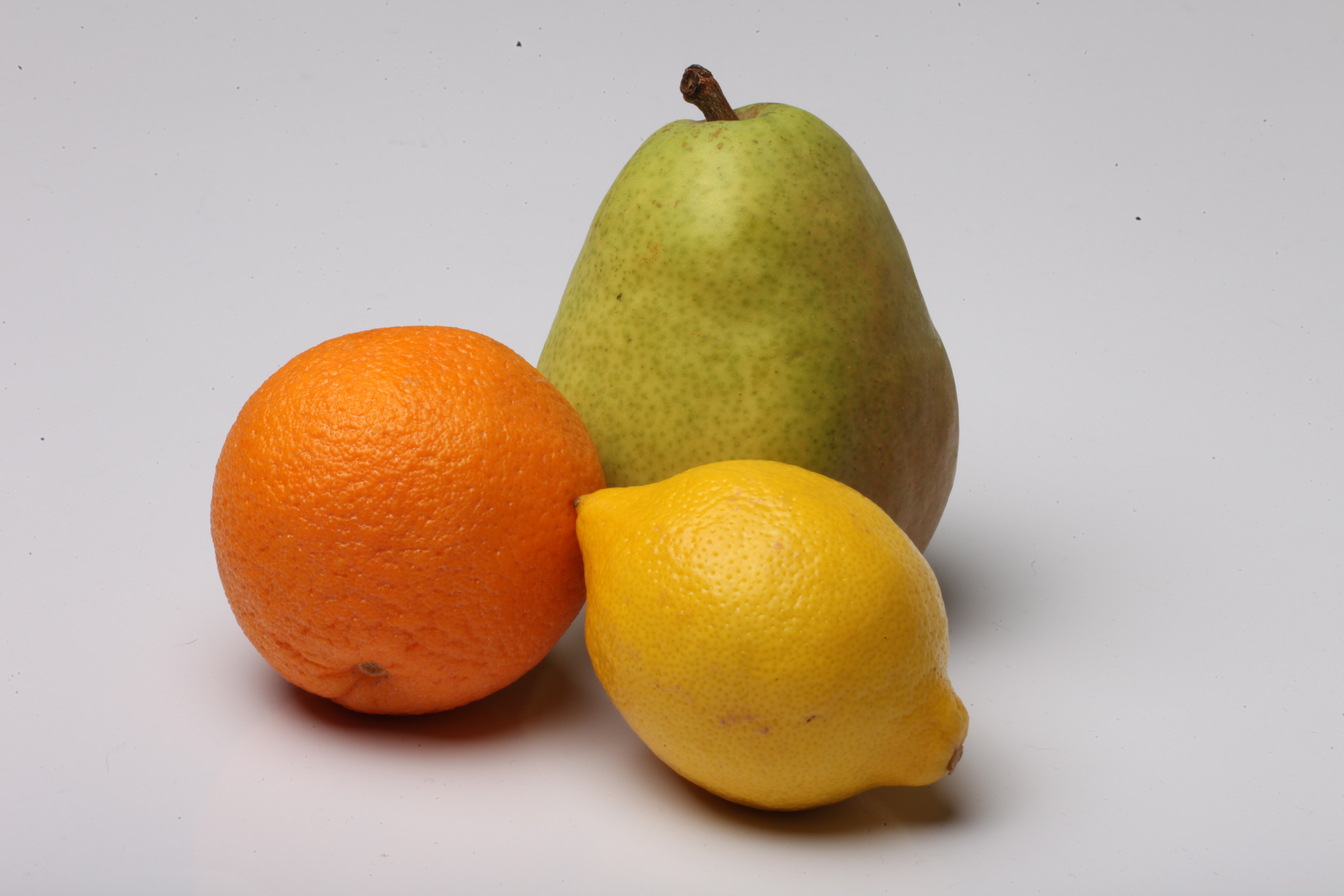 Lemon, pear and orange isolated on white photo