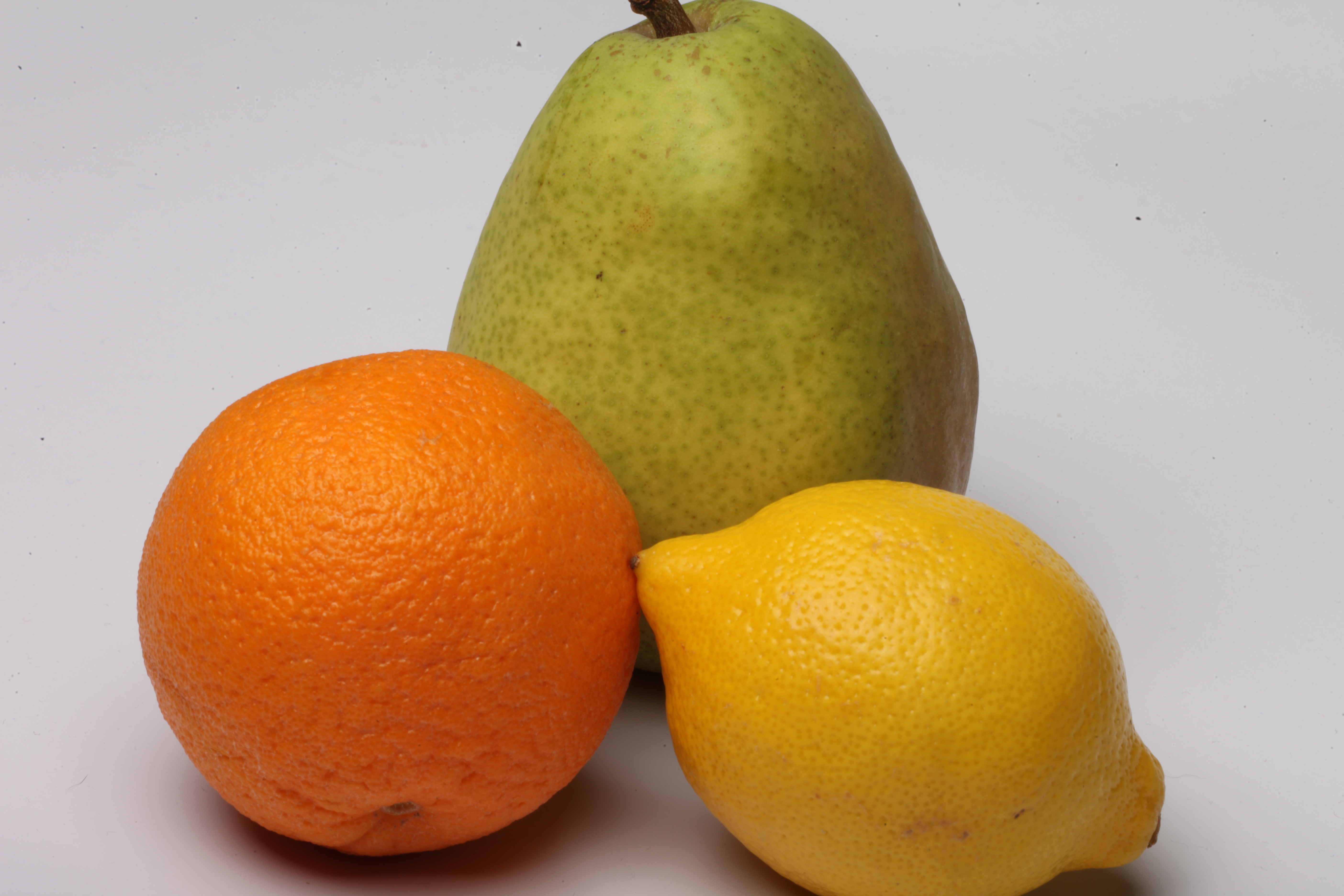 Lemon, pear and orange isolated on white photo