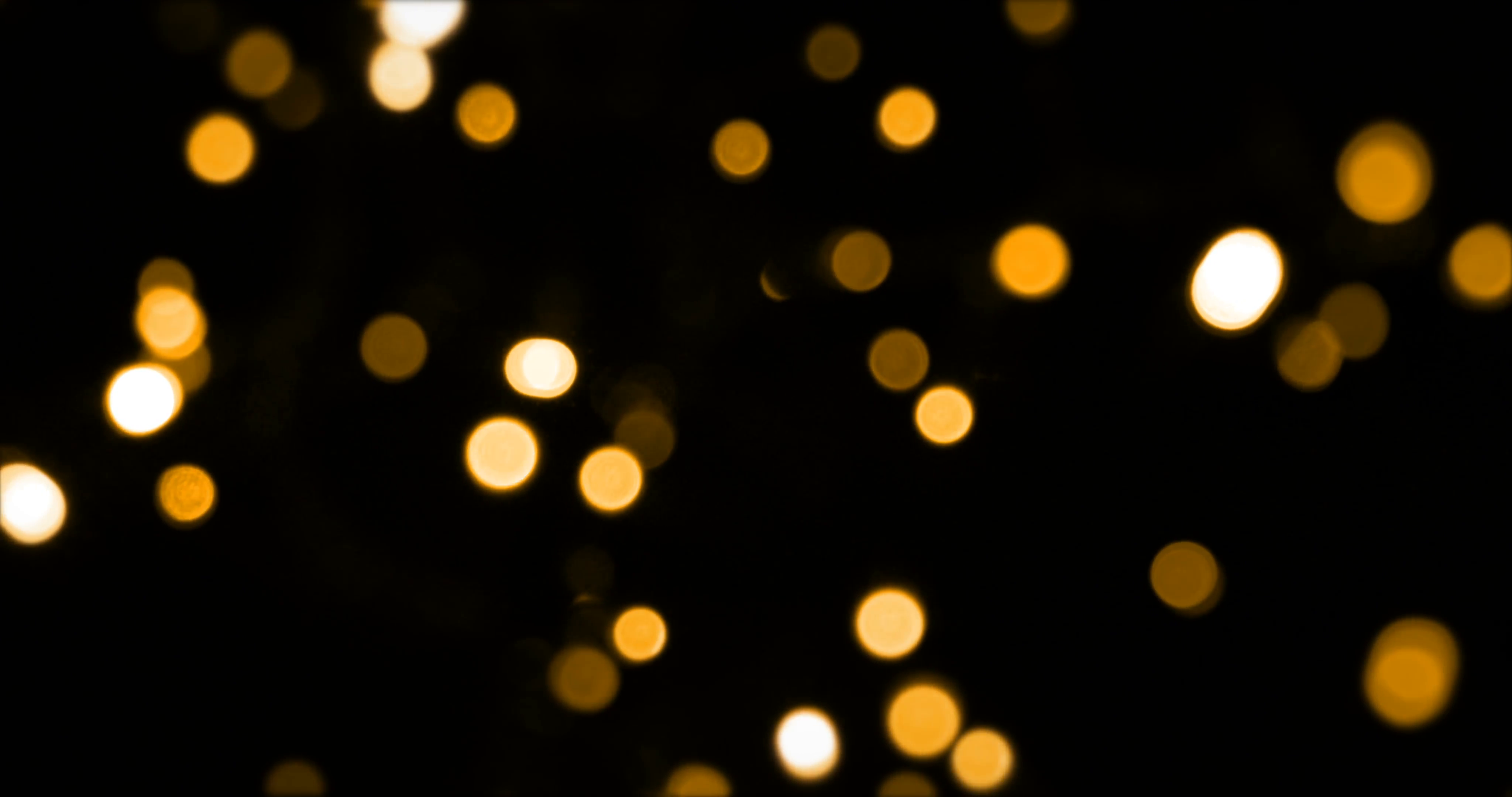 defocused bokeh gold Christmas light on dark background, horizontal ...