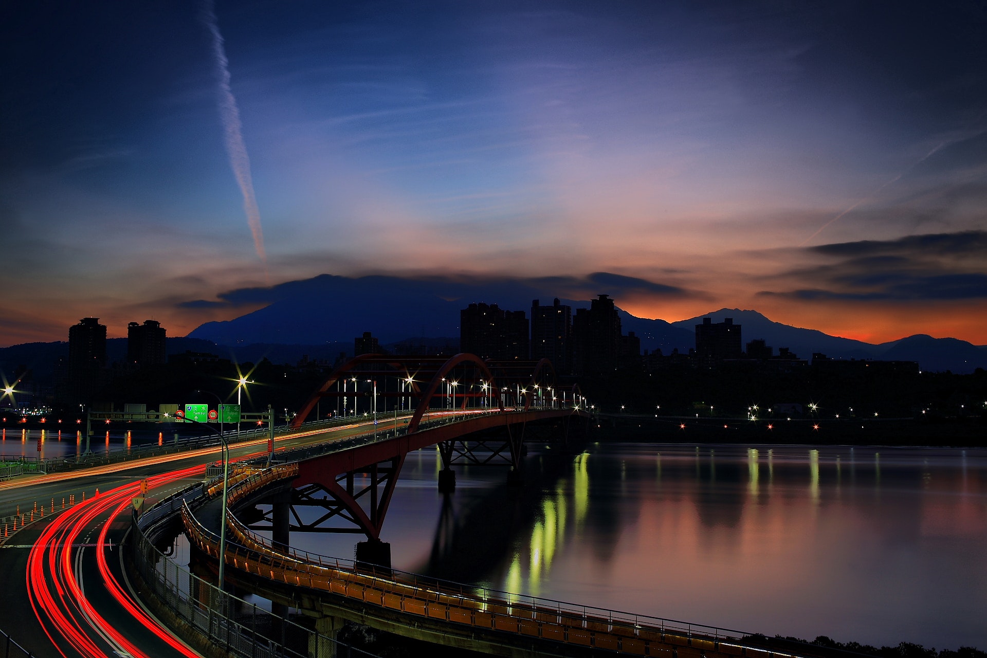 Light rays on bridge during nighttime photo