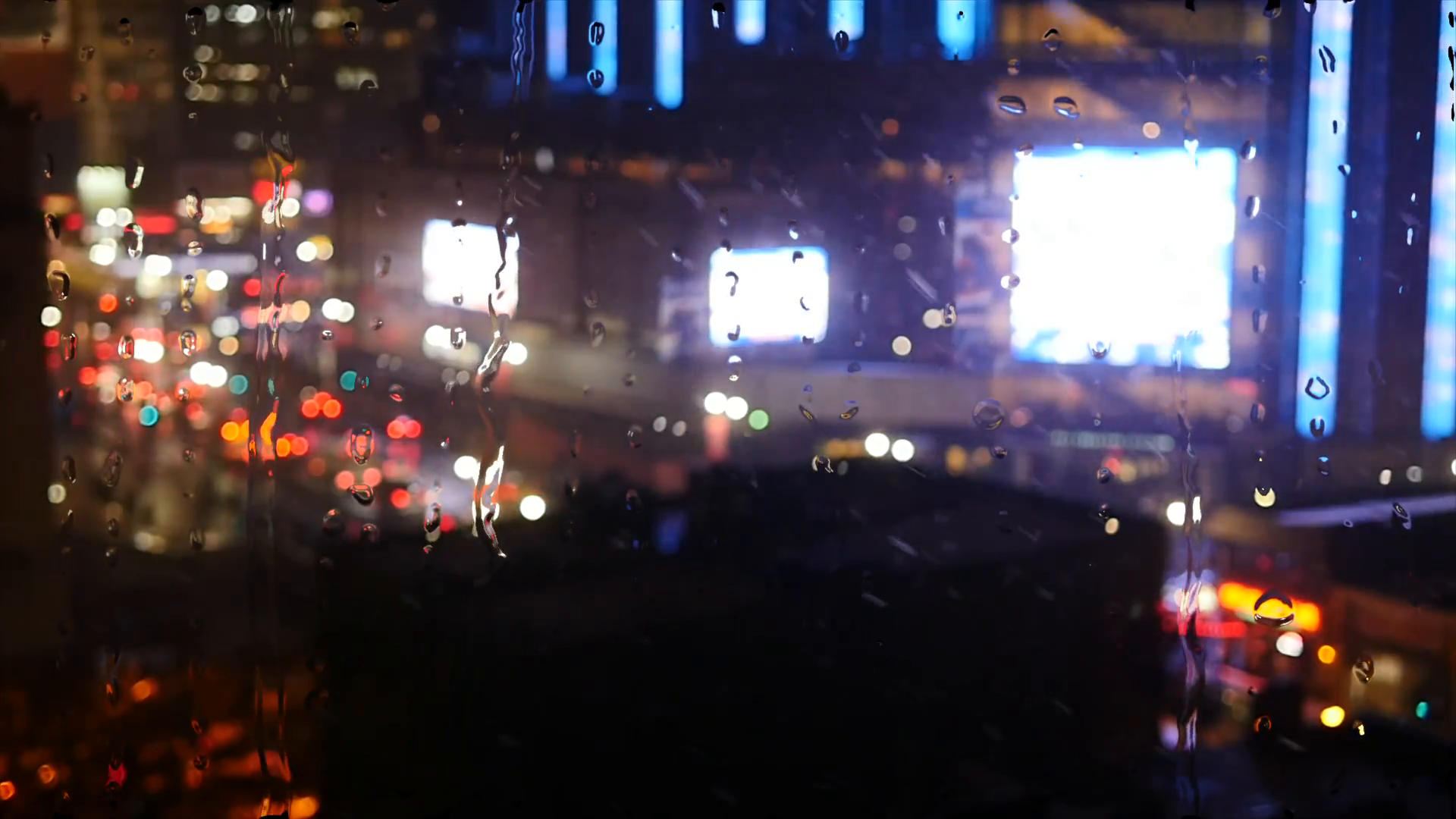 new york city traffic lights at night. rain drops on window ...