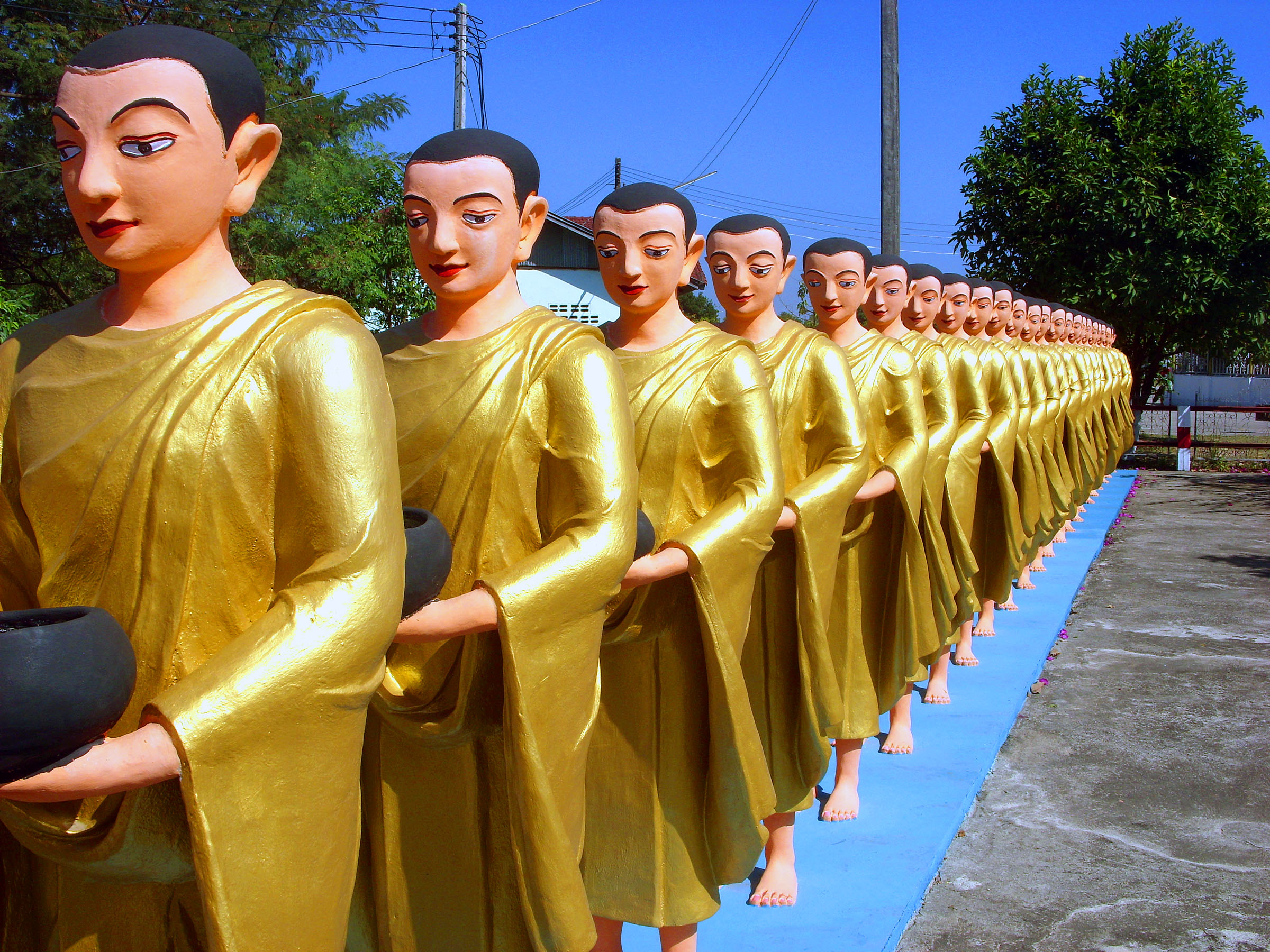 Line of buddhist monk statues photo