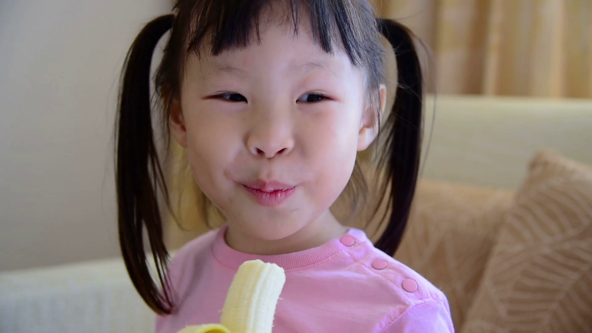 Little asian girl eating banana Stock Video Footage - VideoBlocks