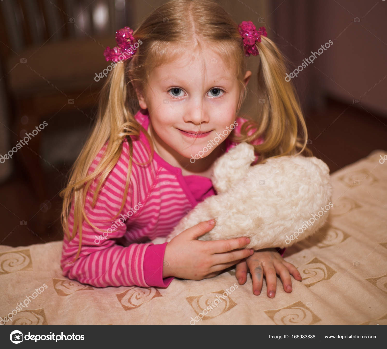 Little blonde girl with a soft toy — Stock Photo © kanareva #166983888