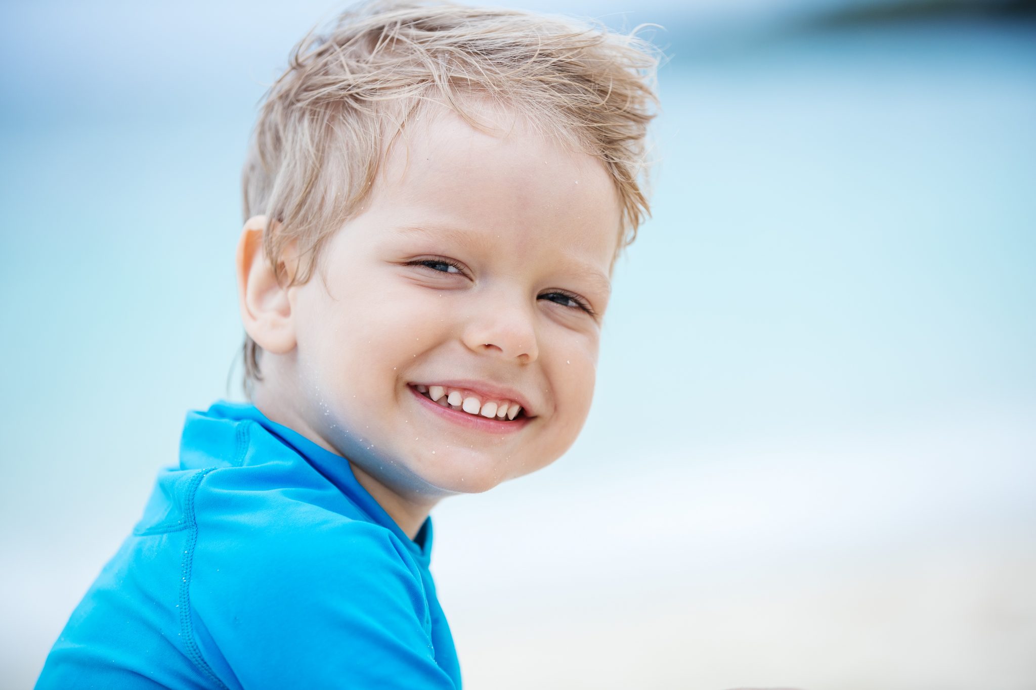 smiling-little-boy-on-the-beach-PKESYV2 | French Family Dentistry