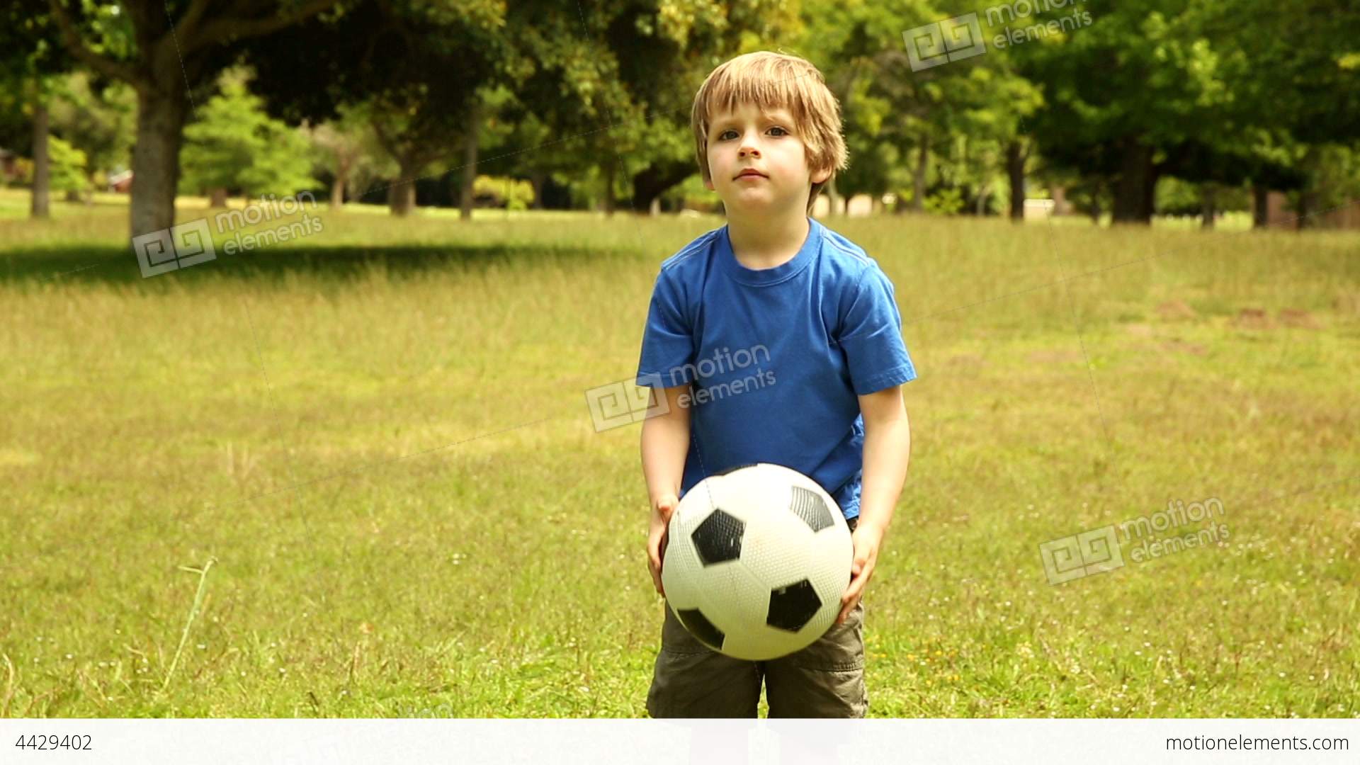 Little Boy Playing Football Stock video footage | 4429402