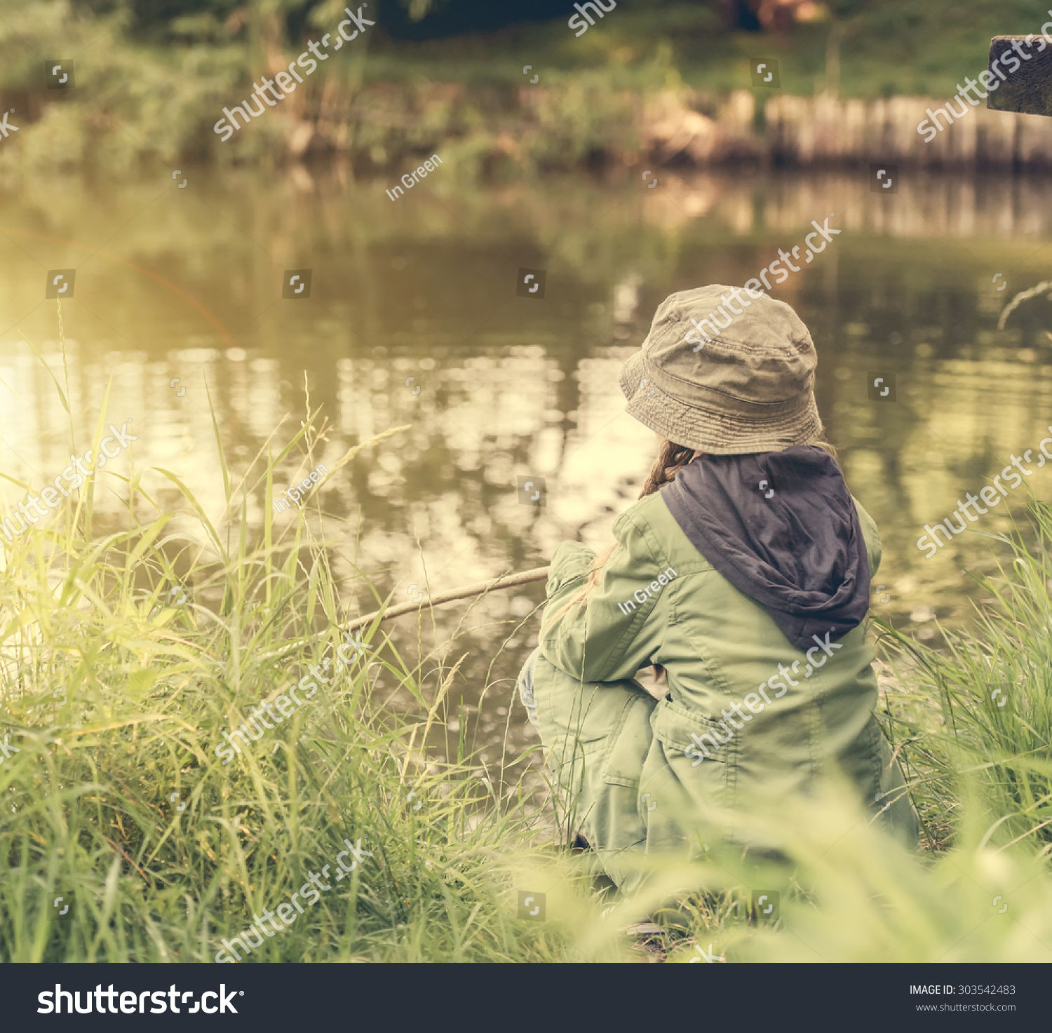 Little Fisher Girl Sitting On River Stock Photo (Edit Now)- Shutterstock