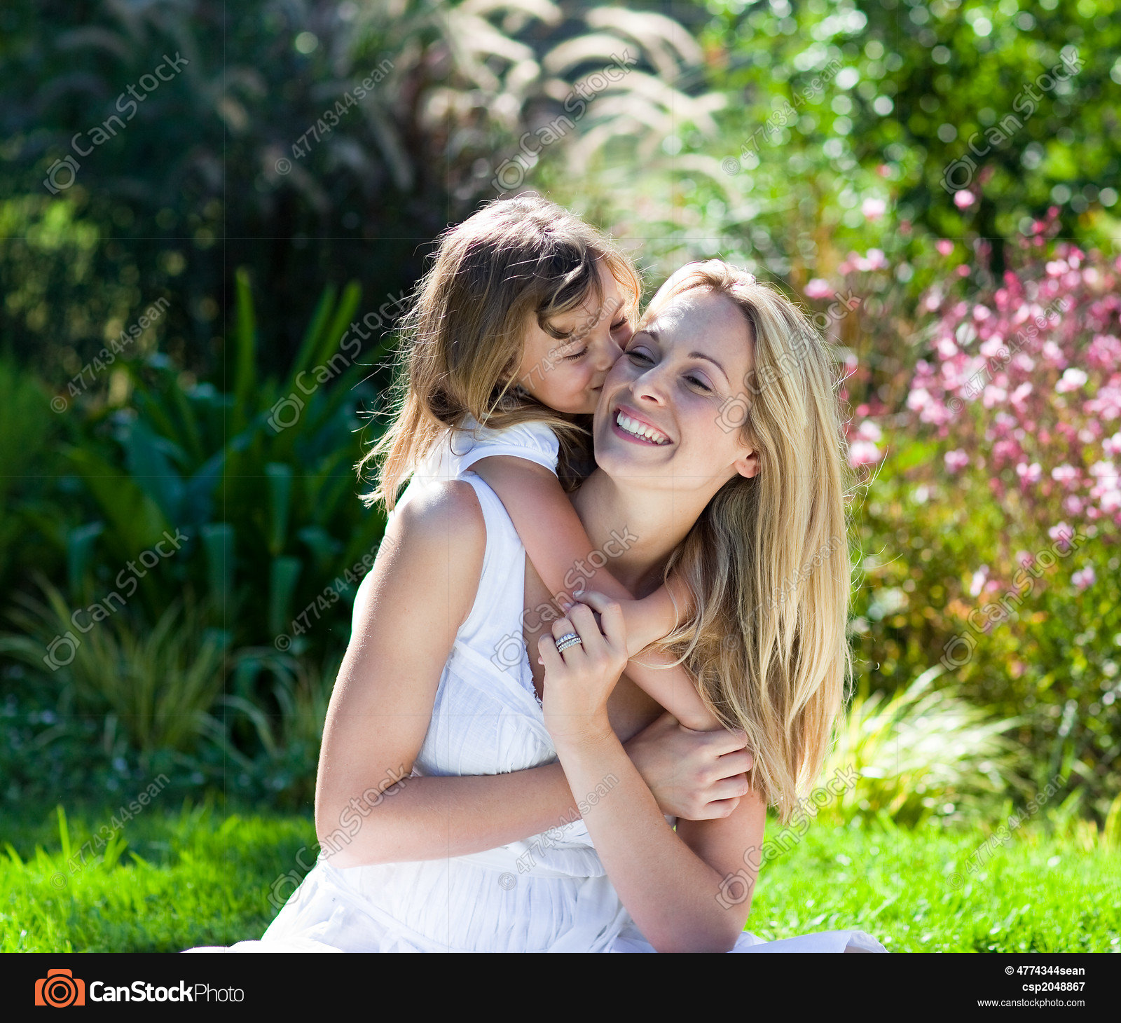 Little girl kissing her mother in a park picture - Search Photo ...