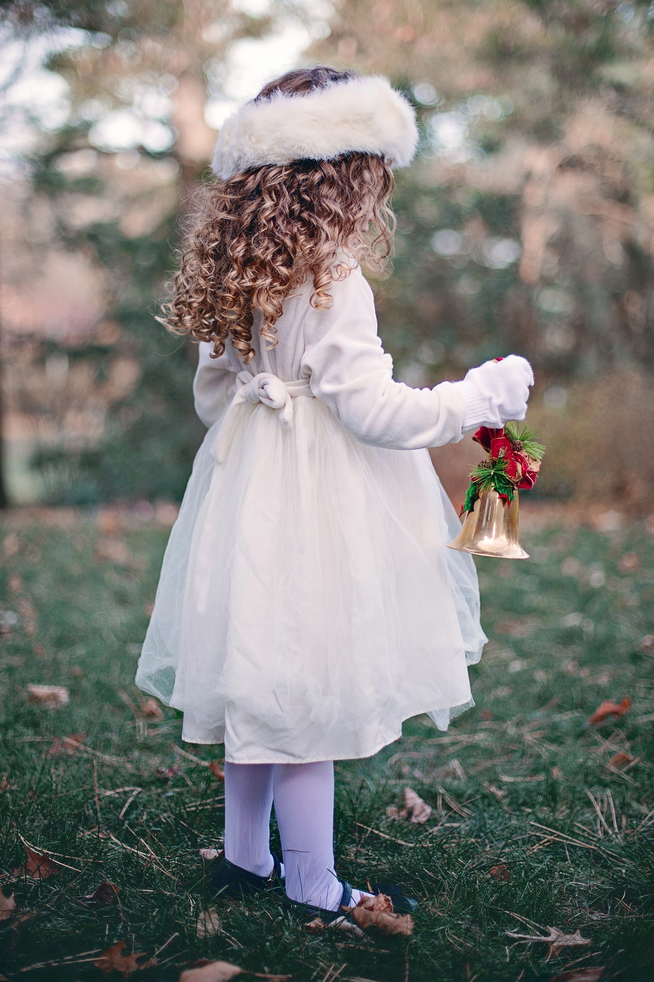 Little girl holding a christmas bell photo
