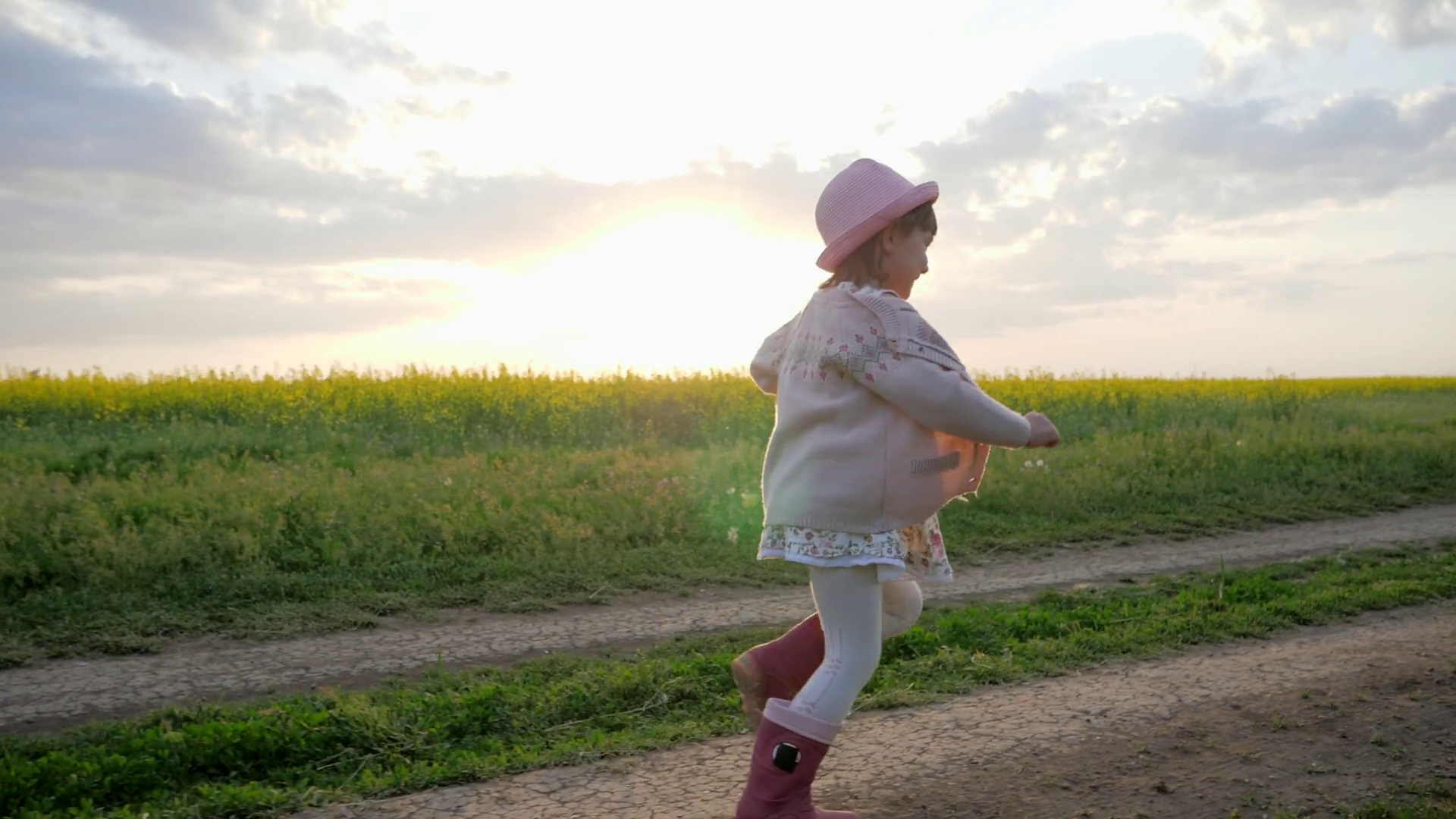 smiling female child, little girl runs along field road, Running ...