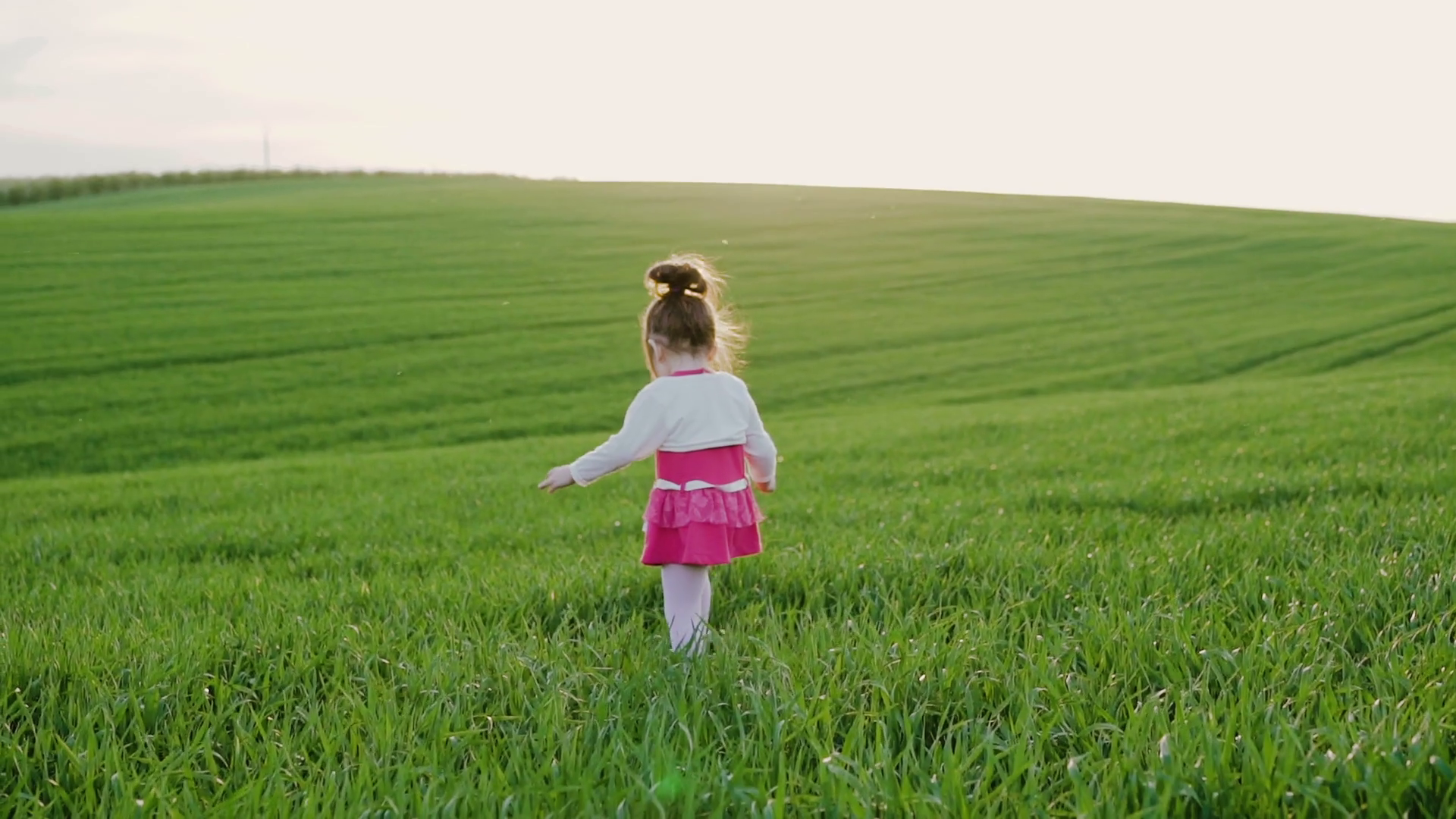 A baby boy running to a little girl on the green field Stock Video ...