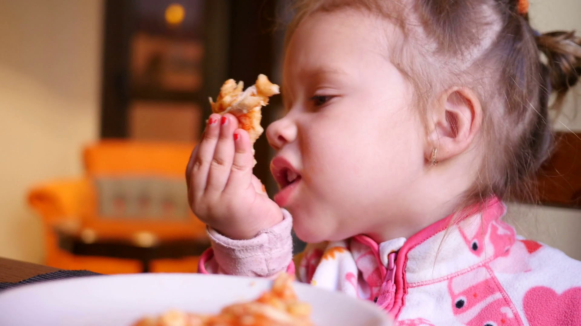 Little kid girl eating tasty pizza at a restaurant table - kid in ...