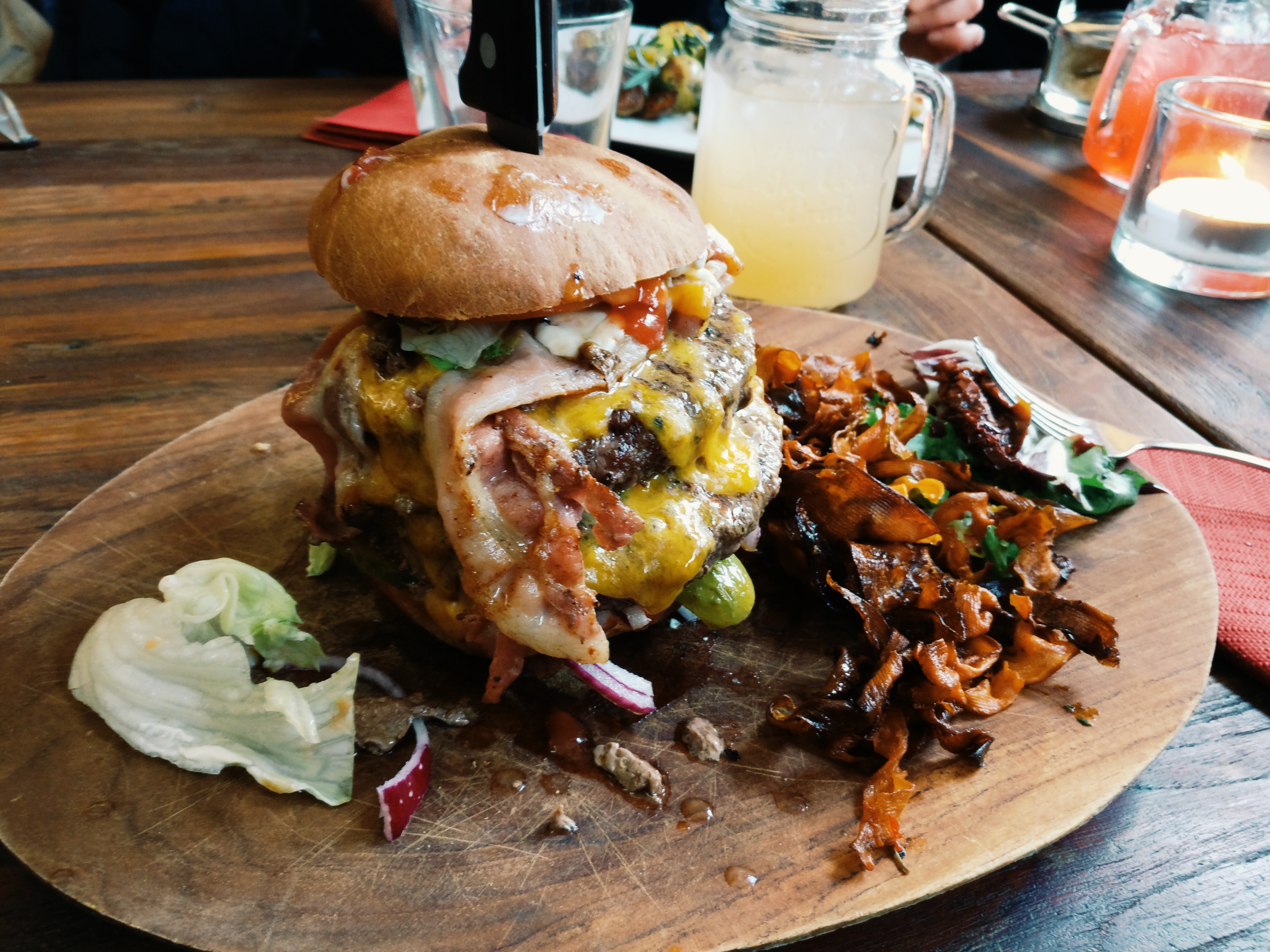 Loaded burger on wooden plate photo