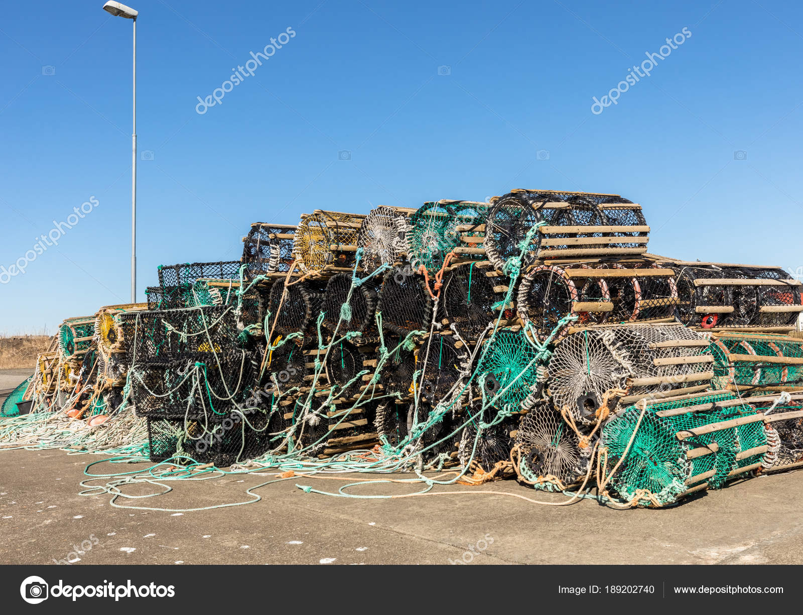A selection of lobster pots on land, in the small fishing village ...