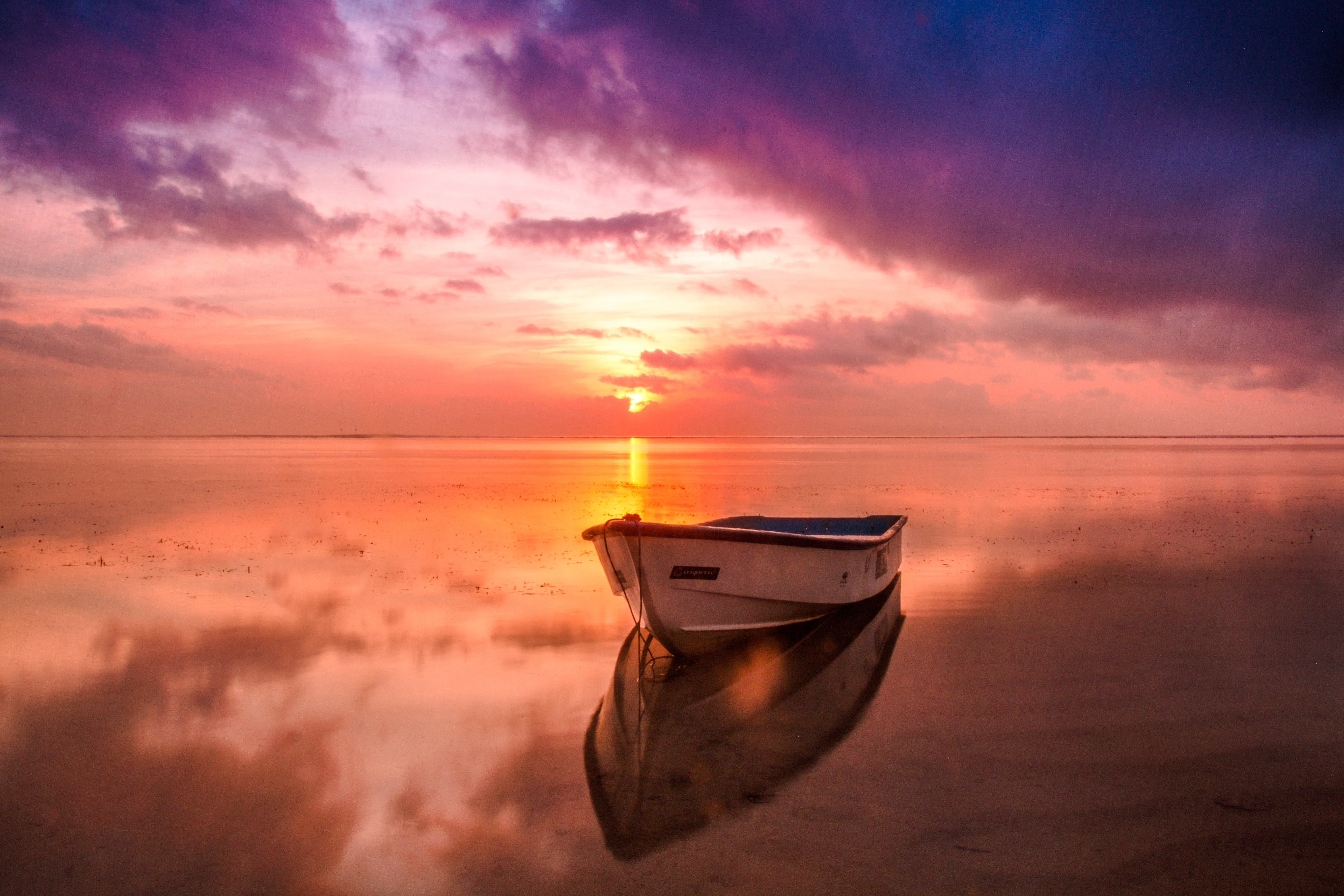 Picalls.com | Lonely boat at sunset by Nuno Obey.