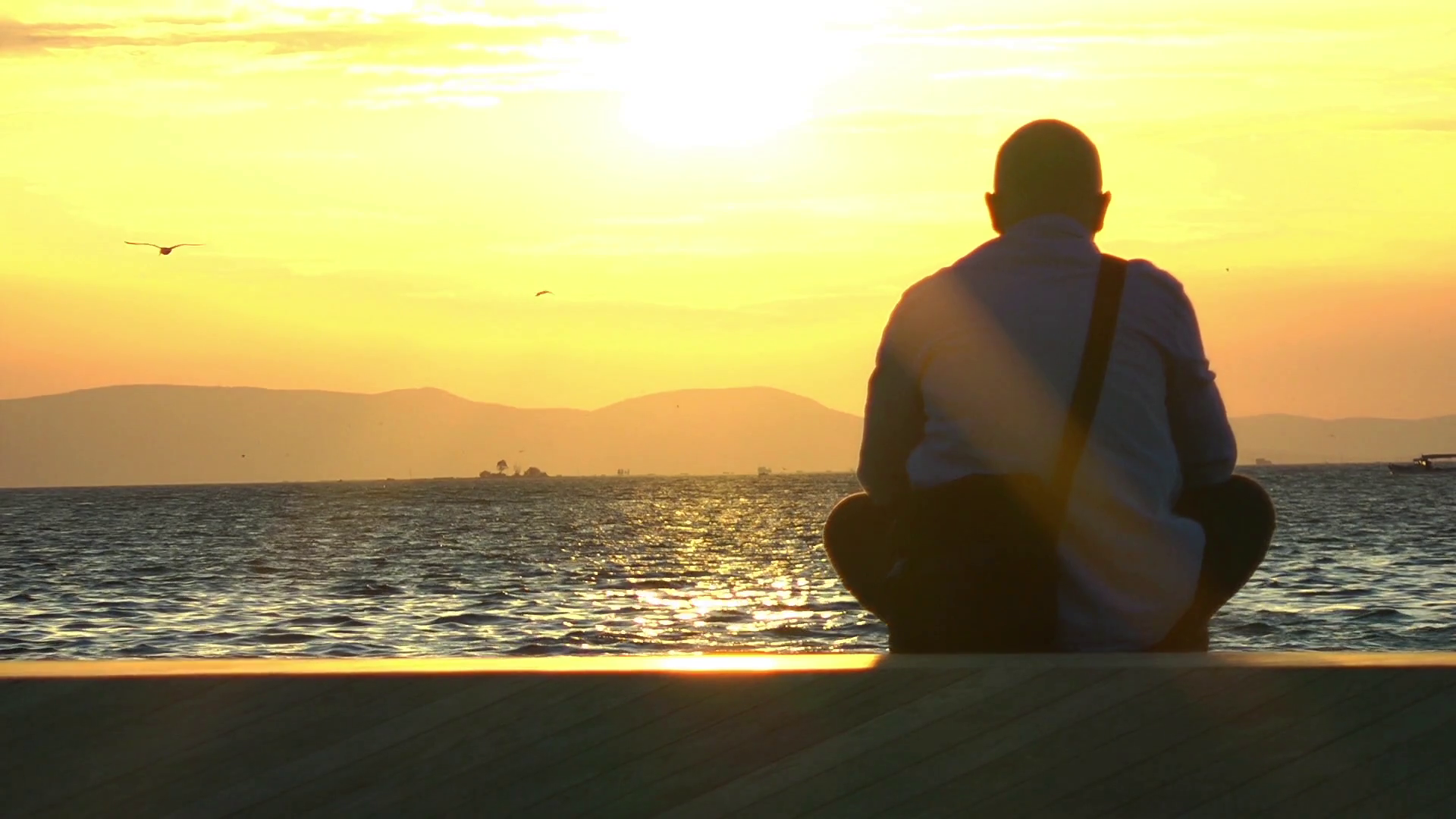 Lonely man at seaside in sunset time Stock Video Footage - Videoblocks