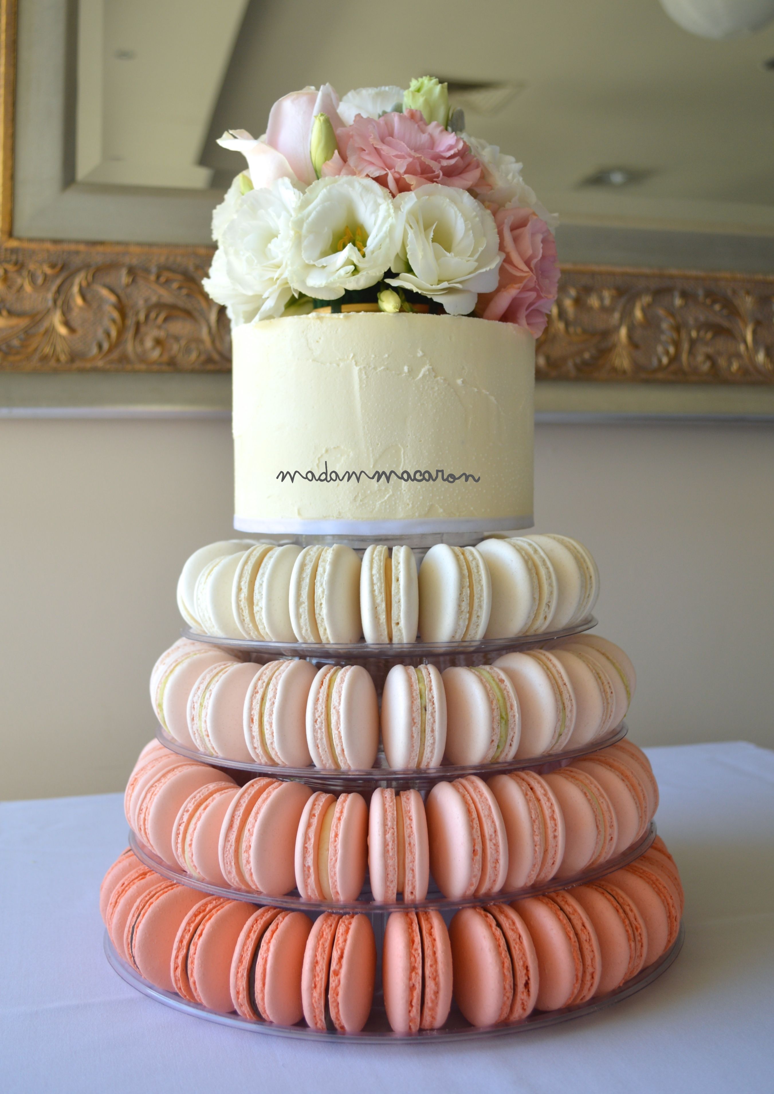 Peach Ombre macaron tower, buttercream cake on top finished with ...