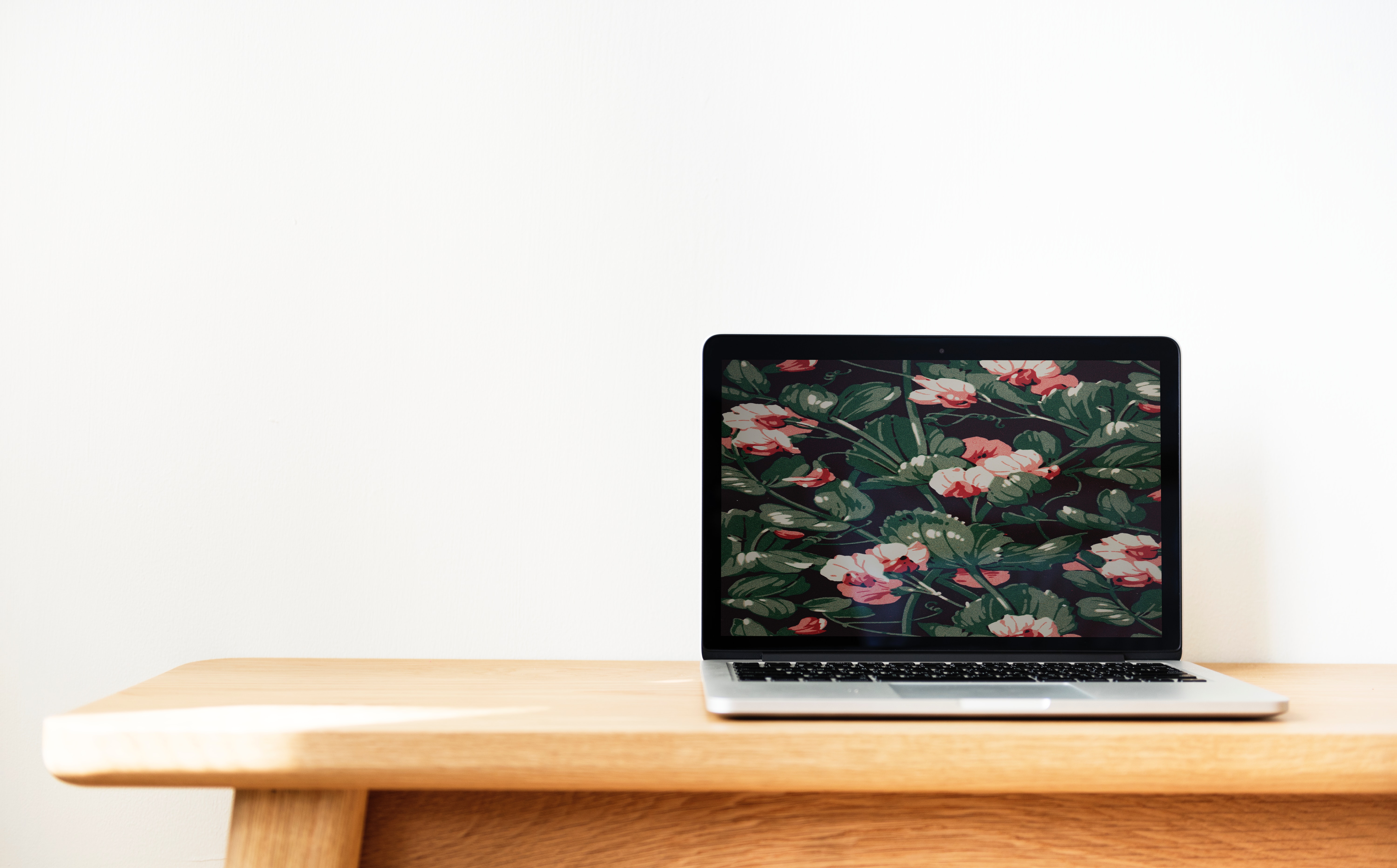 Macbook pro on top of brown desk photo