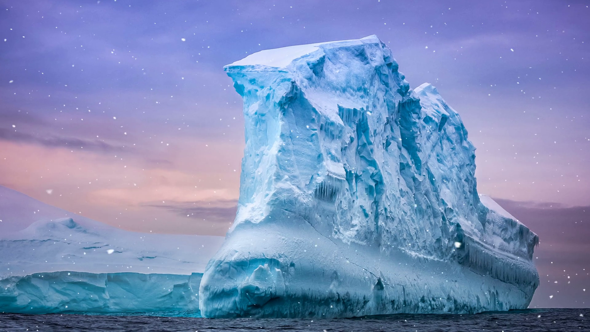 Antarctic Nature. Huge iceberg floats in ocean against colorful ...