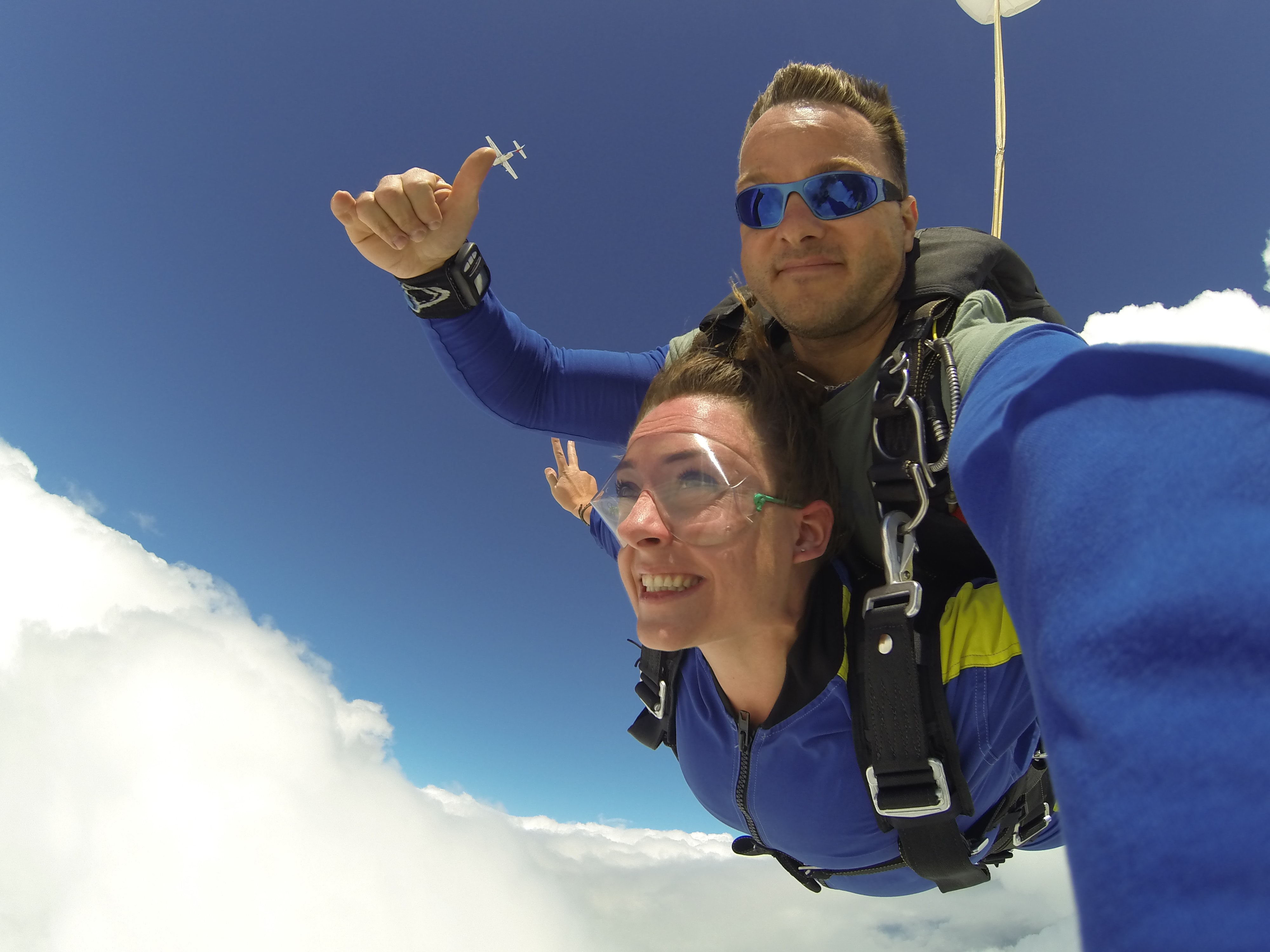 Man and woman in blue jacket doing sky diving photo