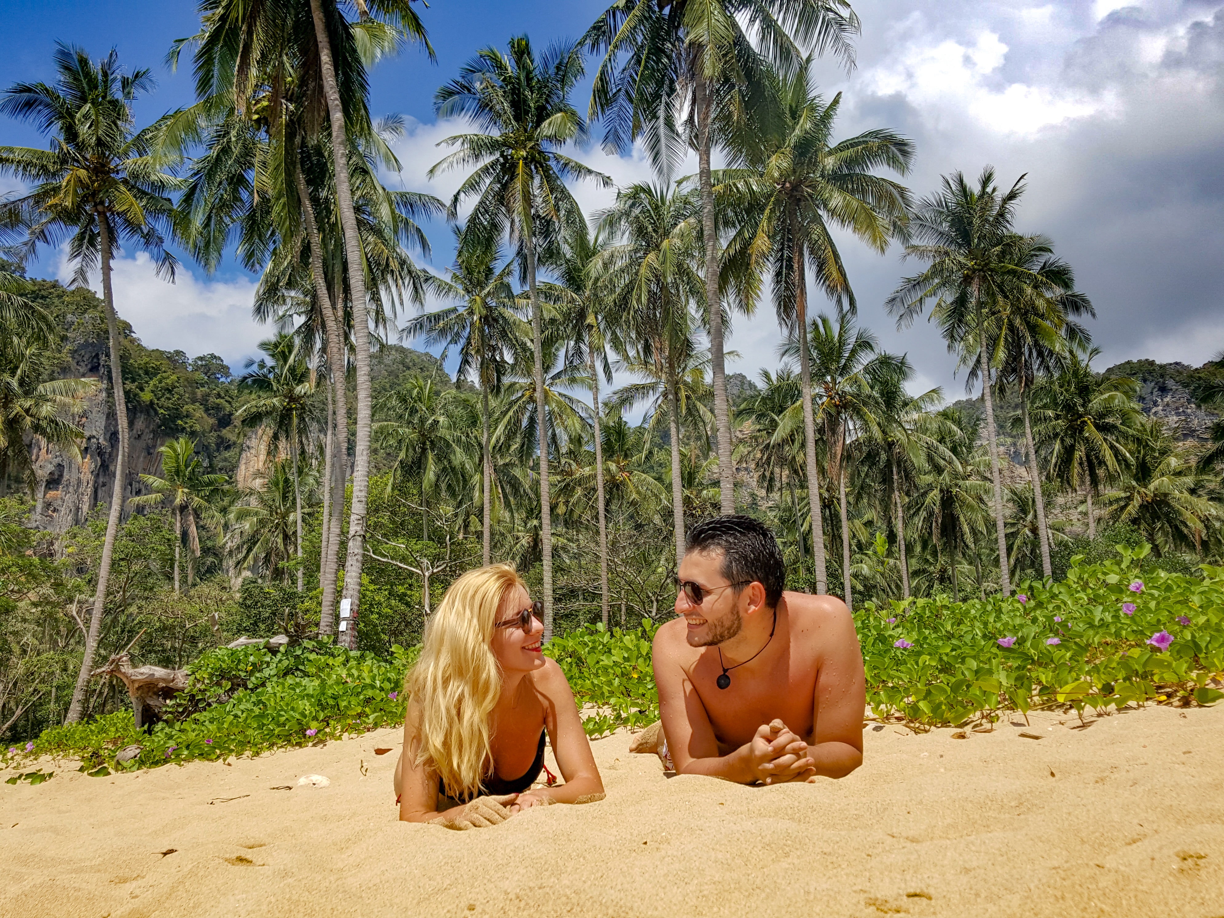 Man and woman lying on sand photo