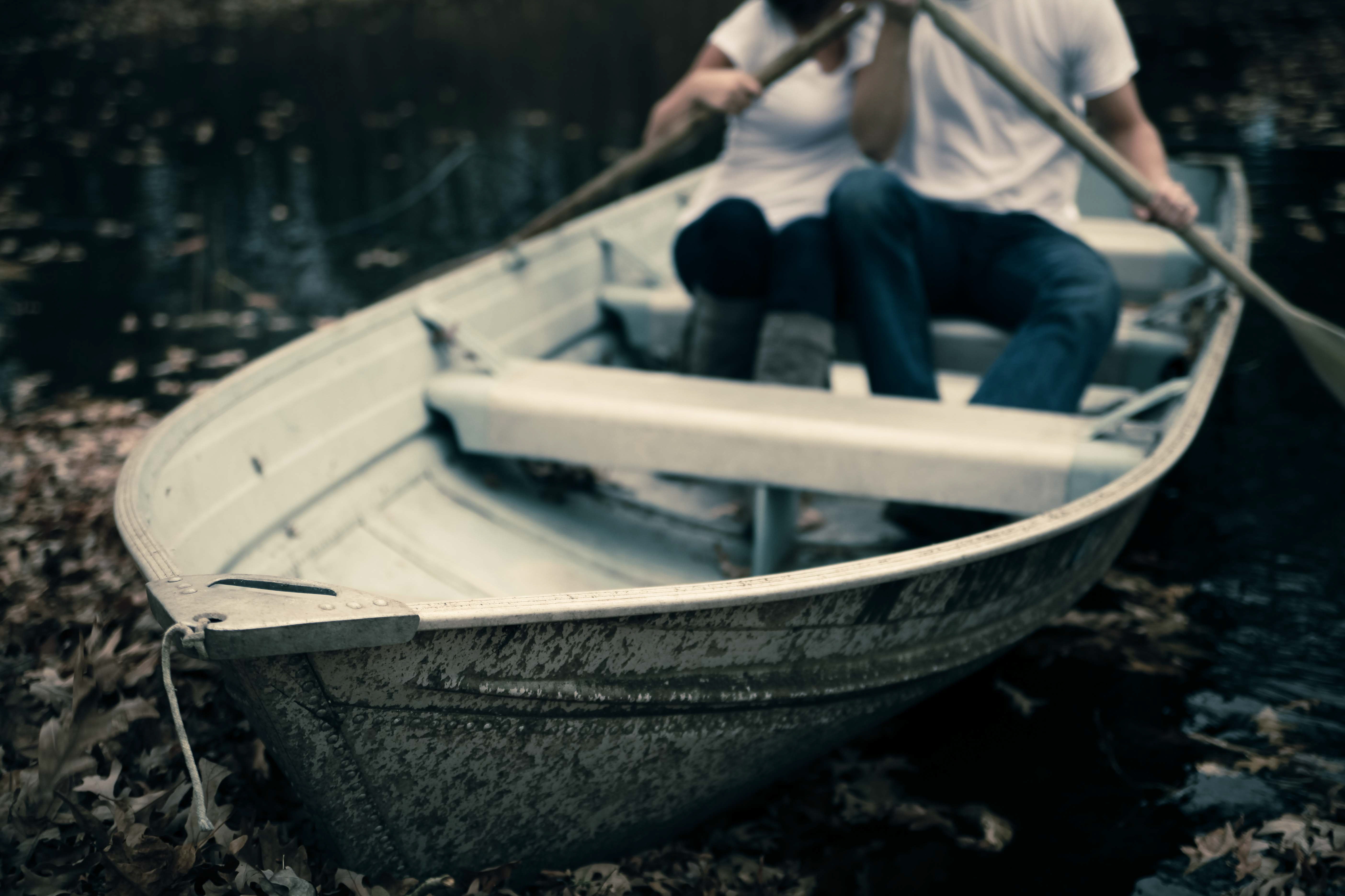 Man and woman sitting on boat holding paddles photo