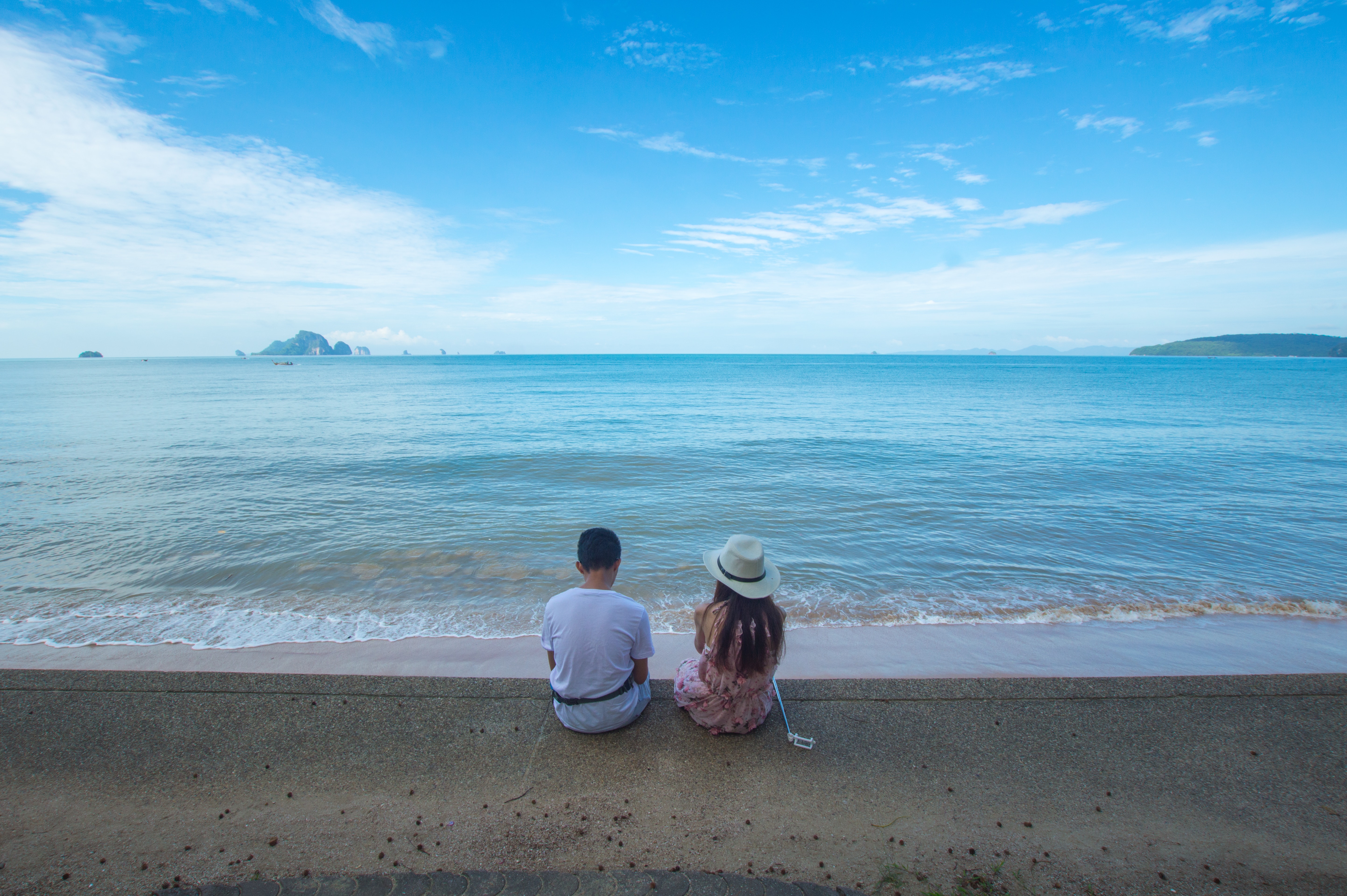 Man and woman sitting on seashore photo