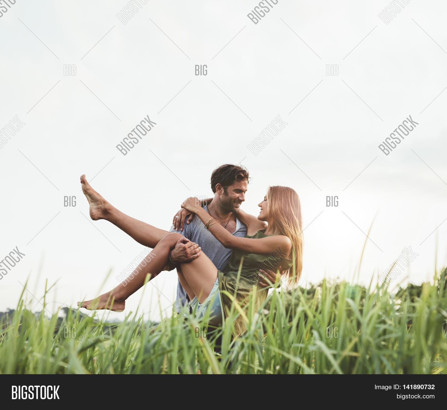 Romantic Man Carrying Woman Field Image & Photo | Bigstock