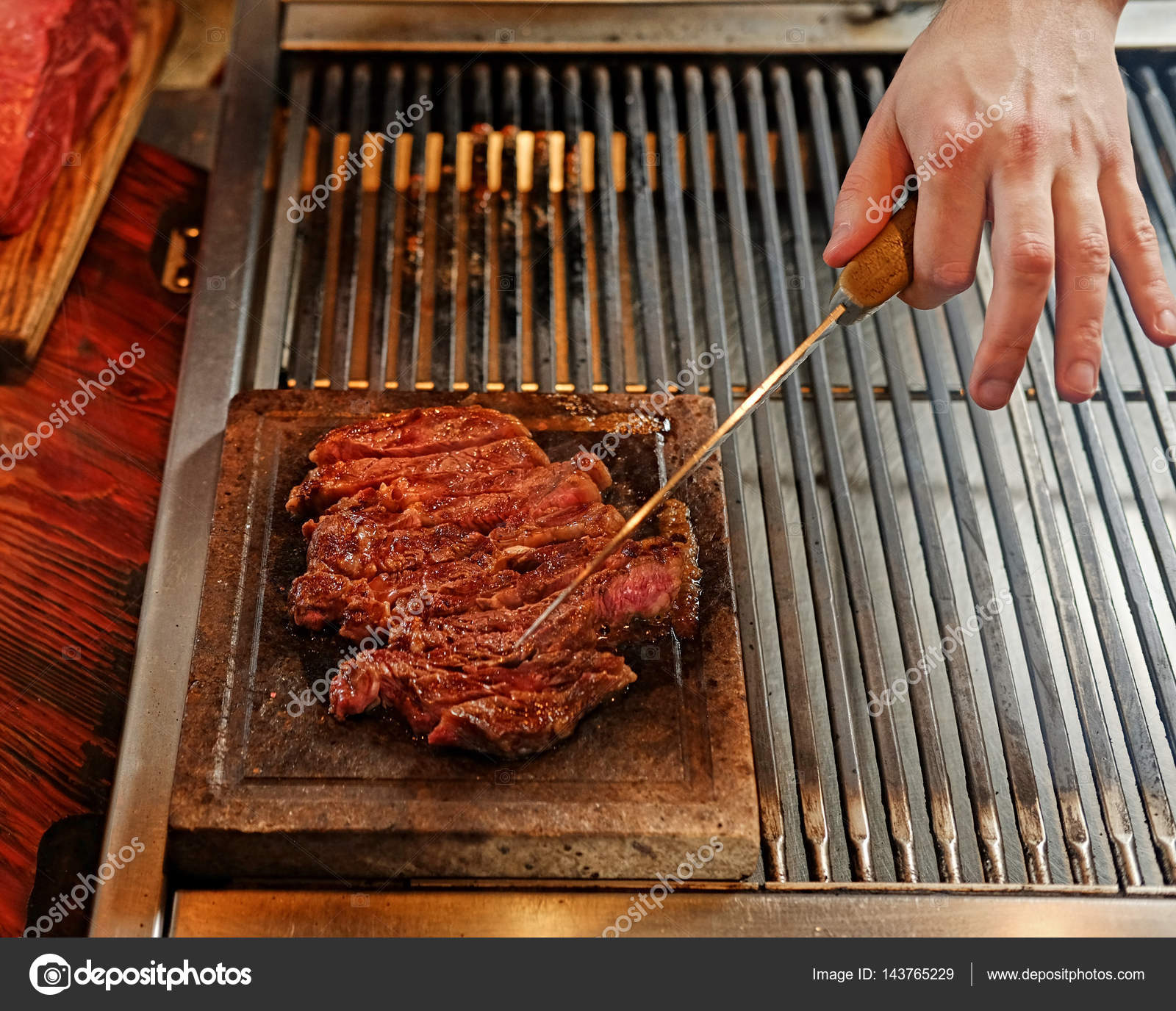 A man cooking beef steak on a grill — Stock Photo © fxquadro #143765229