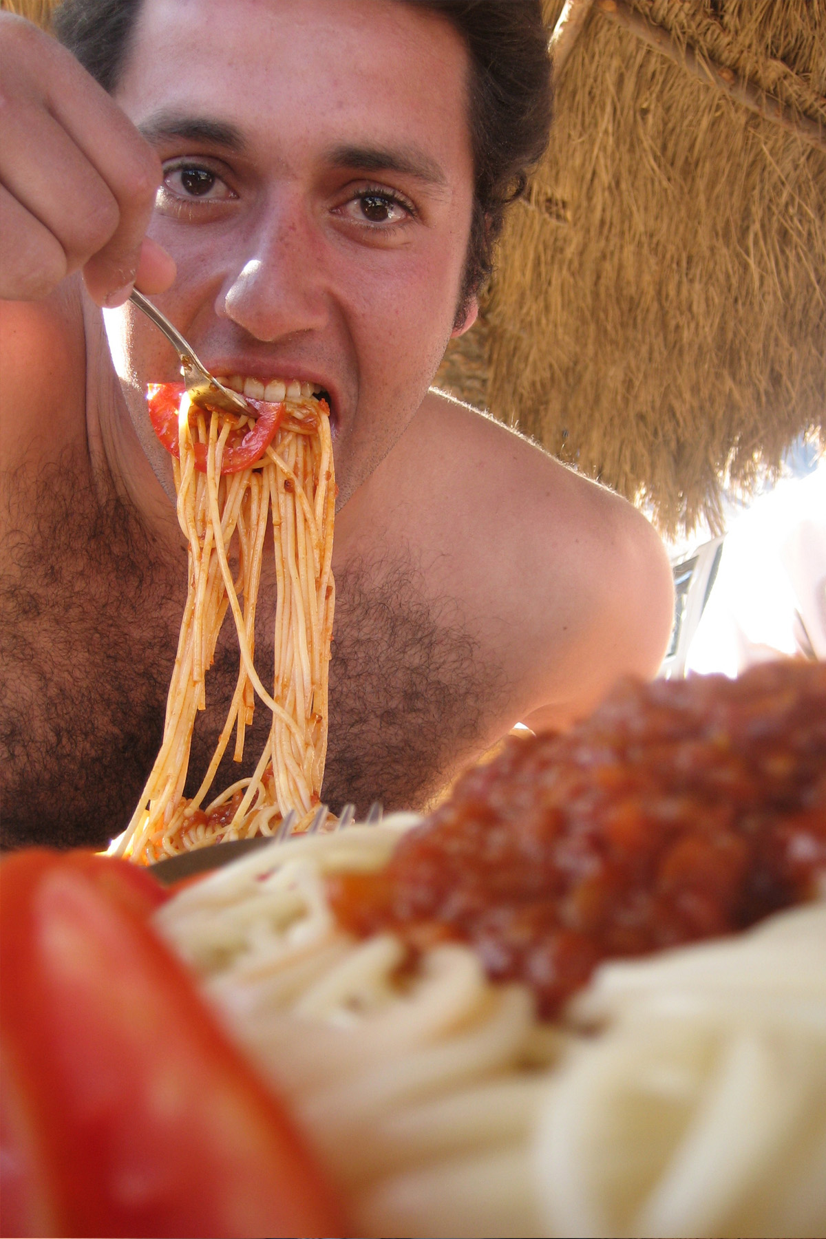 Man eating spaghetti photo