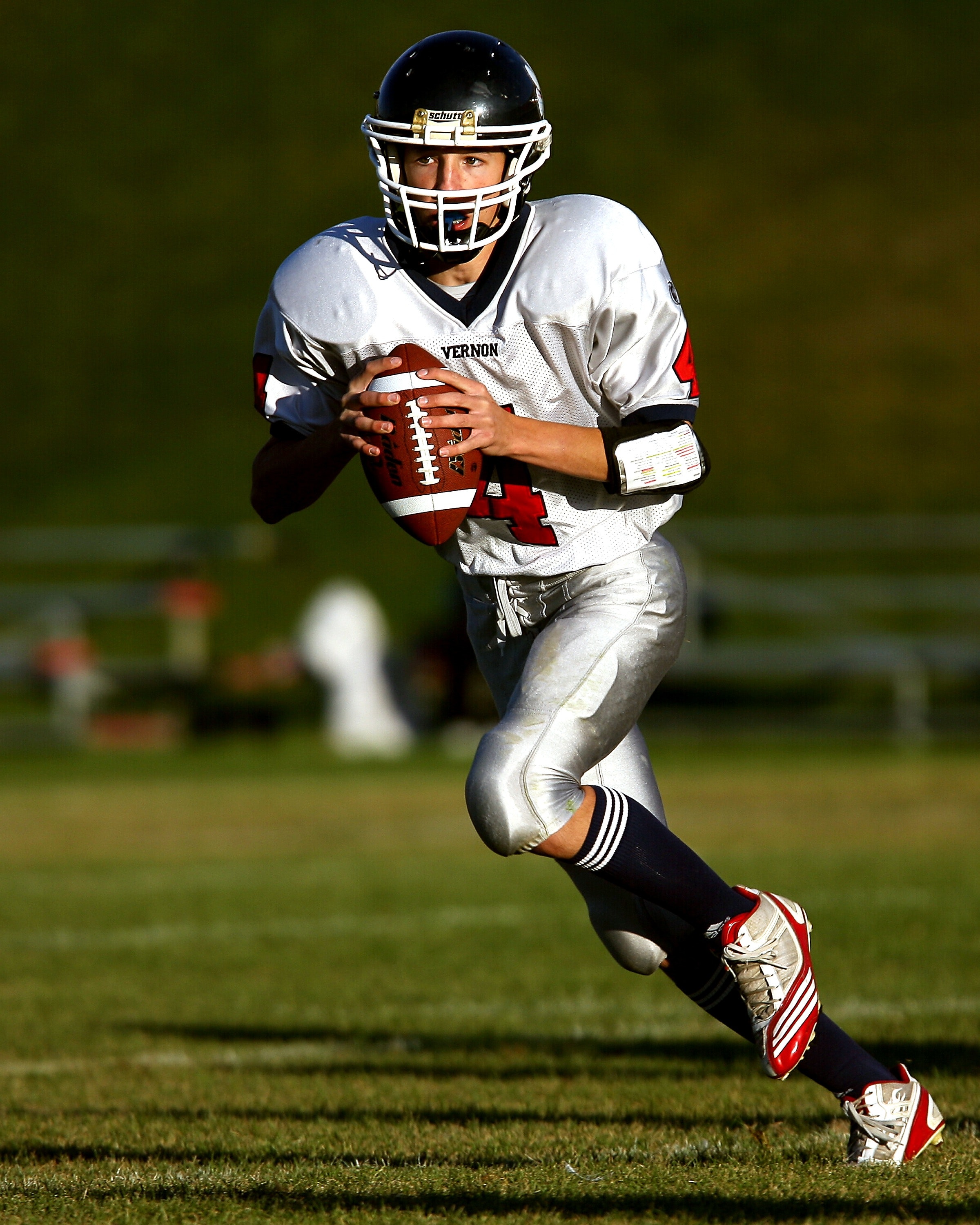 Man holding football while running photo