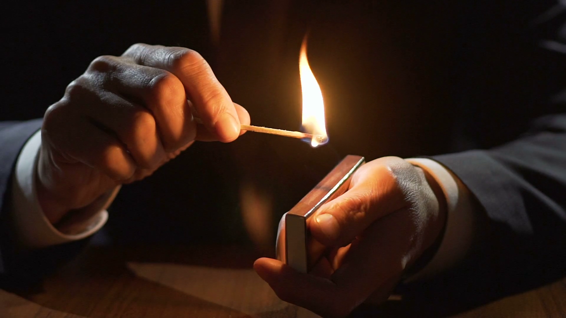 Male hands holding matchbox and burning match, life passes by fast ...